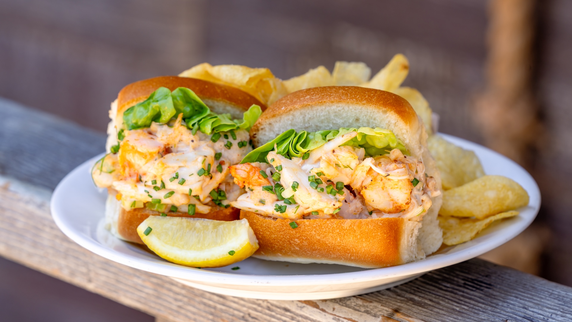 Disney Parks America 250 Foodie Guide Crab and Shrimp Roll: Jumbo lump crab and shrimp salad sandwich served with a bag of potato chips