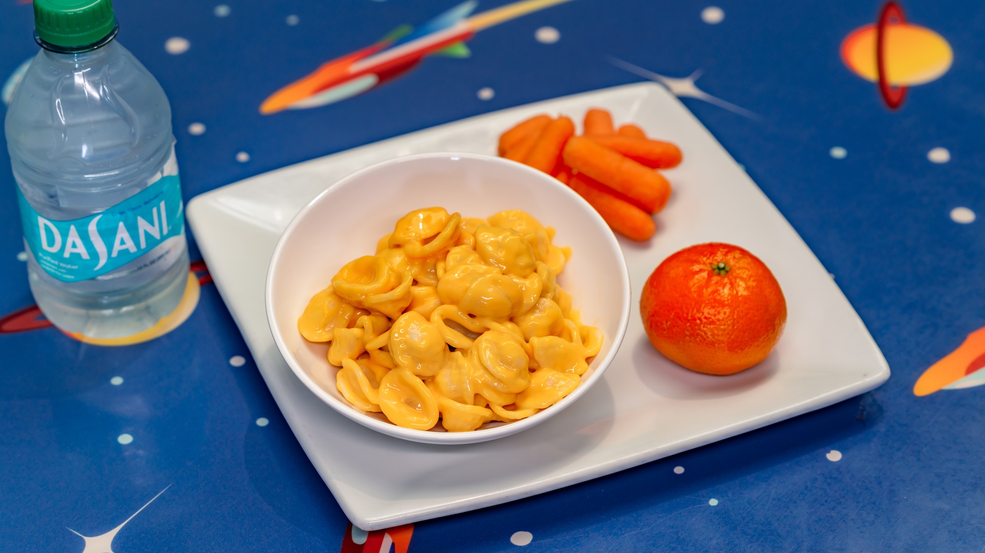 Disneyland Kids Meals Macaroni and Cheese served with carrots, a Cuties Mandarin Orange, and choice of small DASANI Water or small lowfat milk