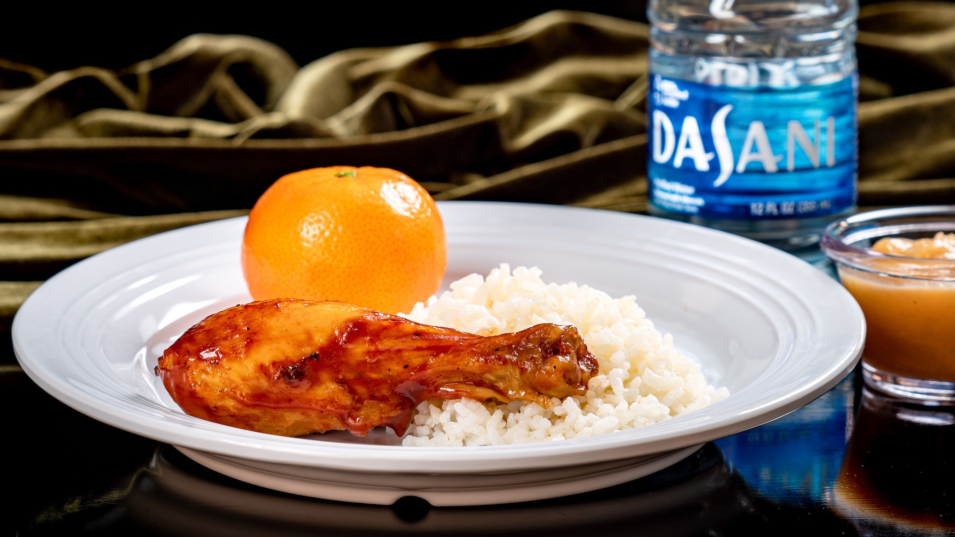 Disneyland Kids Meals Roasted Chicken Drumstick with sweet BBQ sauce and heirloom rice served with a Cuties Mandarin Orange and applesauce with choice of small DASANI Water or small lowfat milk (egg allergy-friendly, fish/shellfish allergy-friendly, gluten/wheat allergy-friendly, and milk allergy-friendly options also available)