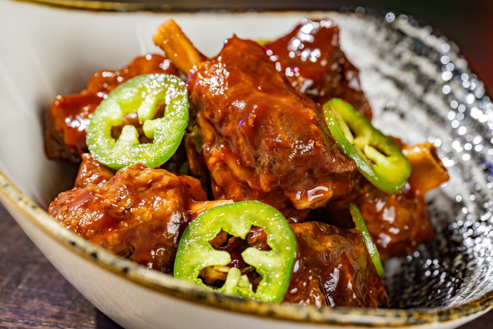 Bowl of Bones: Pork wings fried with jalape&ntilde;os and tossed in barbecue sauce made with Coca-Cola Cherry (Available during Mickey&rsquo;s Not-So-Scary Halloween Party only)