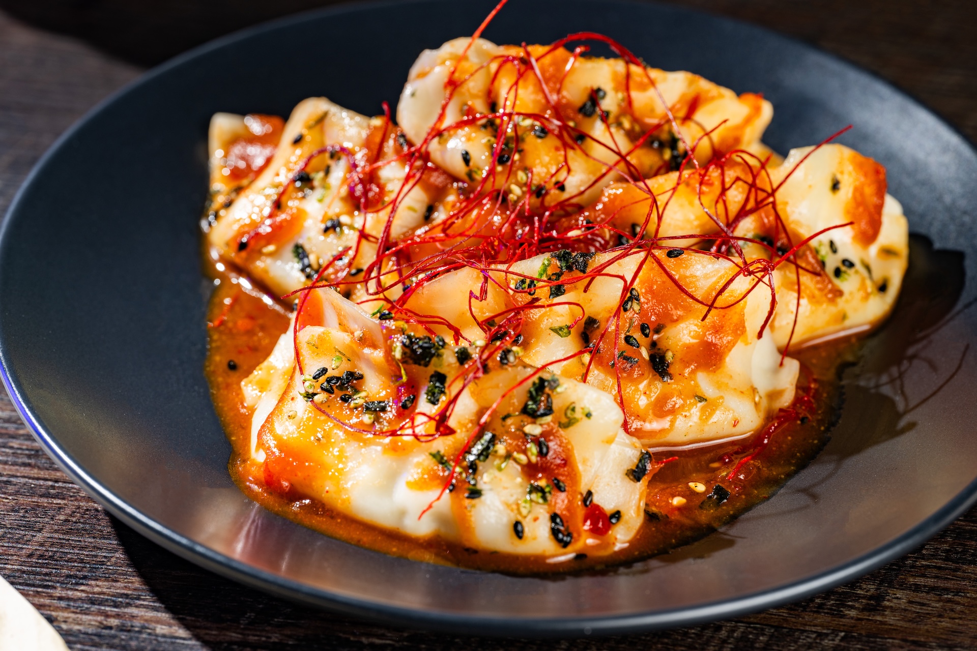 Doom Buggy Dumplings: Chicken dumplings with red miso gochujang sauce, furikake, and chili threads (New) (Available during Mickey&rsquo;s Not-So-Scary Halloween Party only)