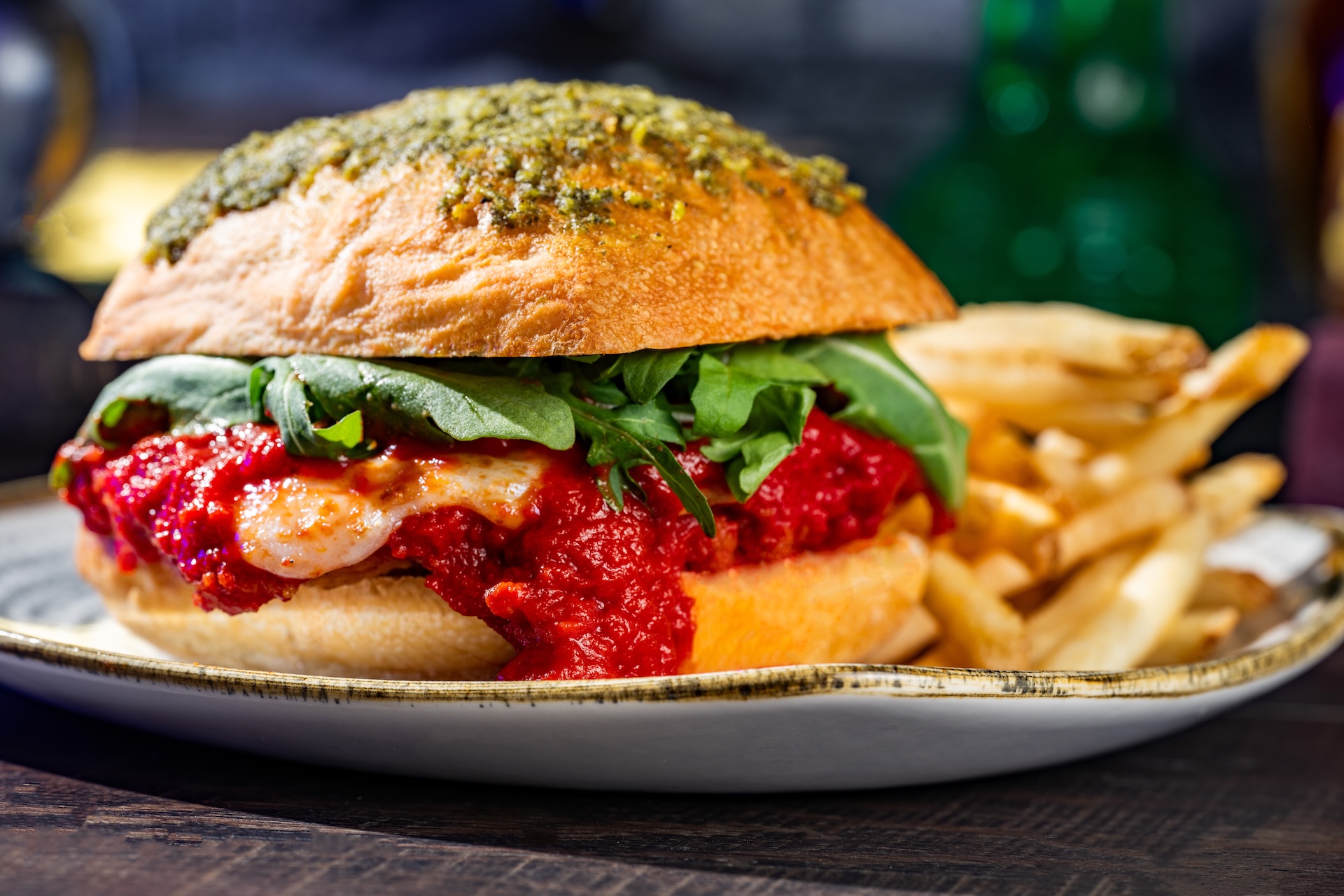 Fra Diavolo Chicken Sandwich: Fried chicken breast with fra diavolo sauce, cheese, basil pesto, and arugula on a ciabatta bun served with french fries (New) (Available during Mickey&rsquo;s Not-So-Scary Halloween Party only)