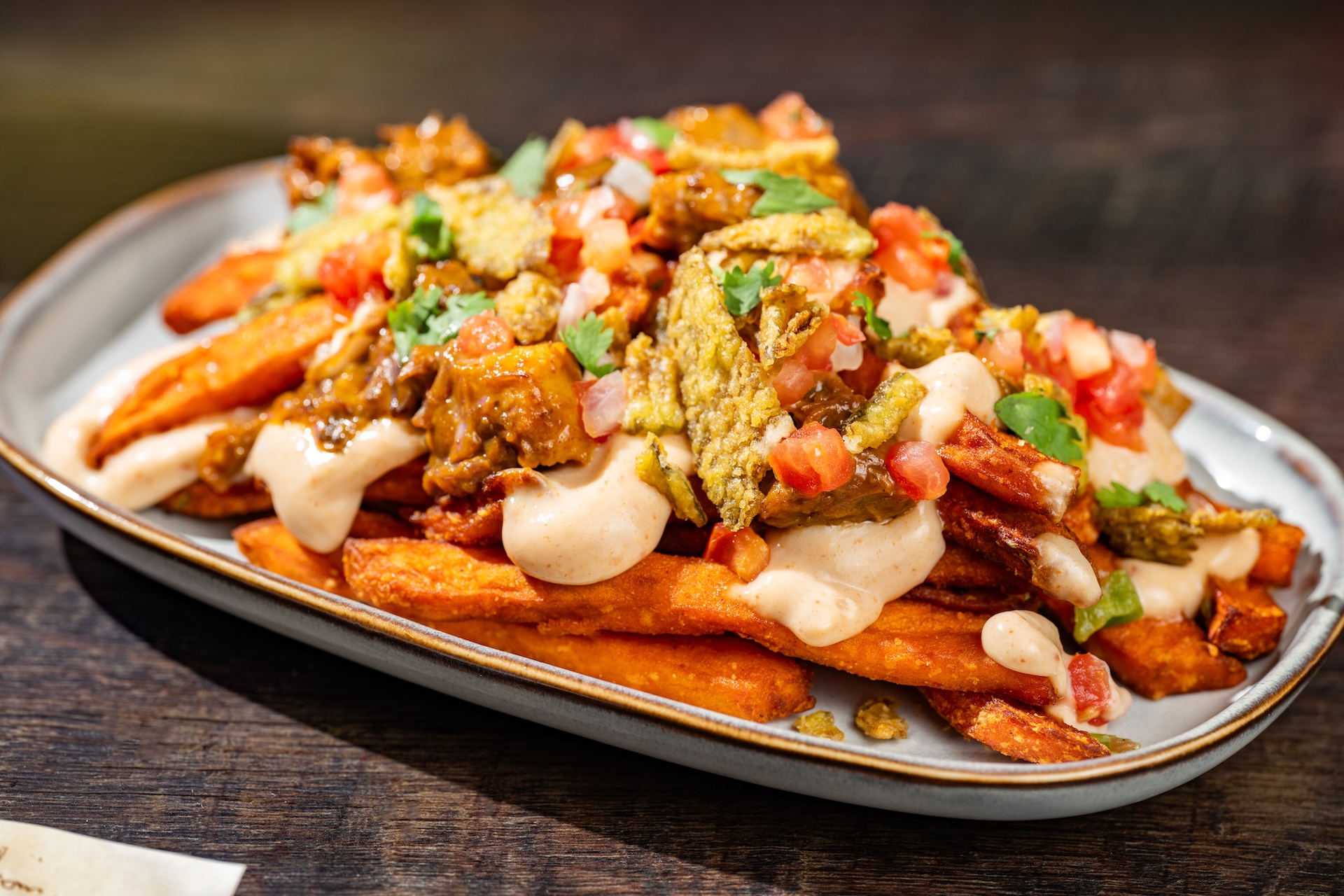 Cursed Cowboy Fries: Sweet potato fries topped with barbecue burnt ends, chipotle queso, pico de gallo, and crispy jalape&ntilde;os (New) (Available during Mickey&rsquo;s Not-So-Scary Halloween Party only)