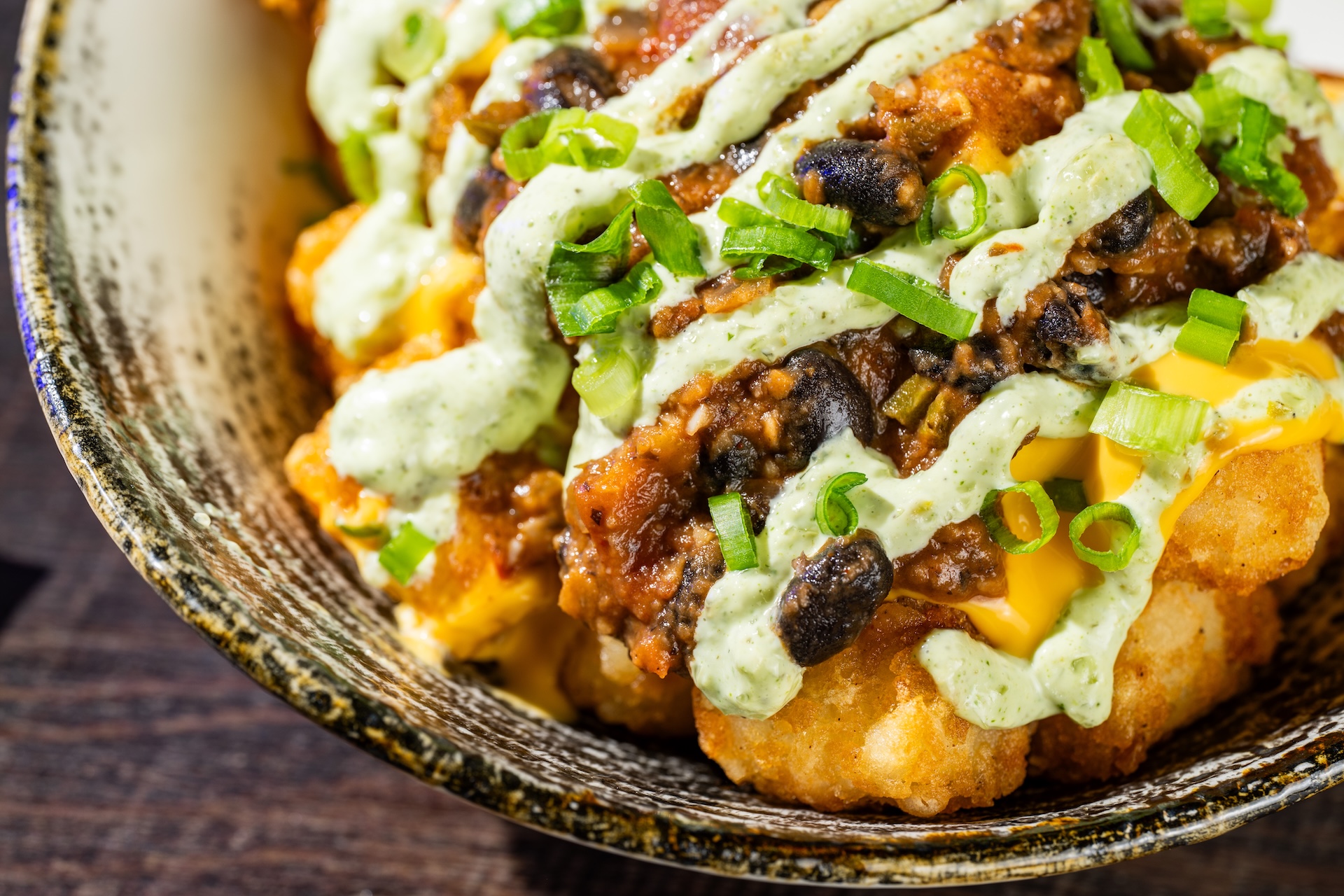 Haunting Jalape&ntilde;o Tots: Tots topped with plant-based black bean chili, cheddar sauce, and jalape&ntilde;o sauce (Available during Mickey&rsquo;s Not-So-Scary Halloween Party only)