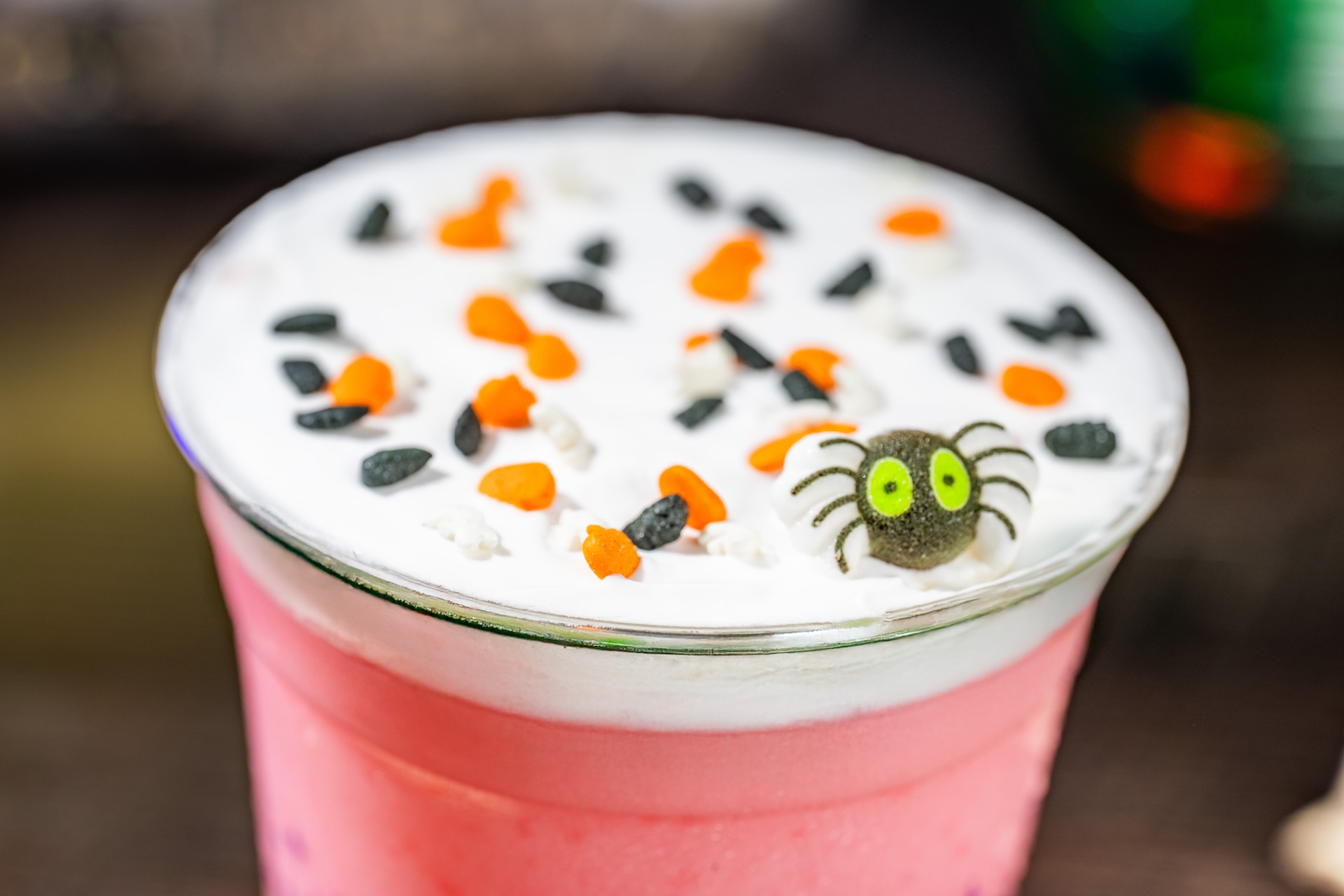 Guava Lemonade Slushy with cheesecake foam, Halloween sprinkles, and a sugar spider (Non-alcoholic) (Available during Mickey&rsquo;s Not-So-Scary Halloween Party only)