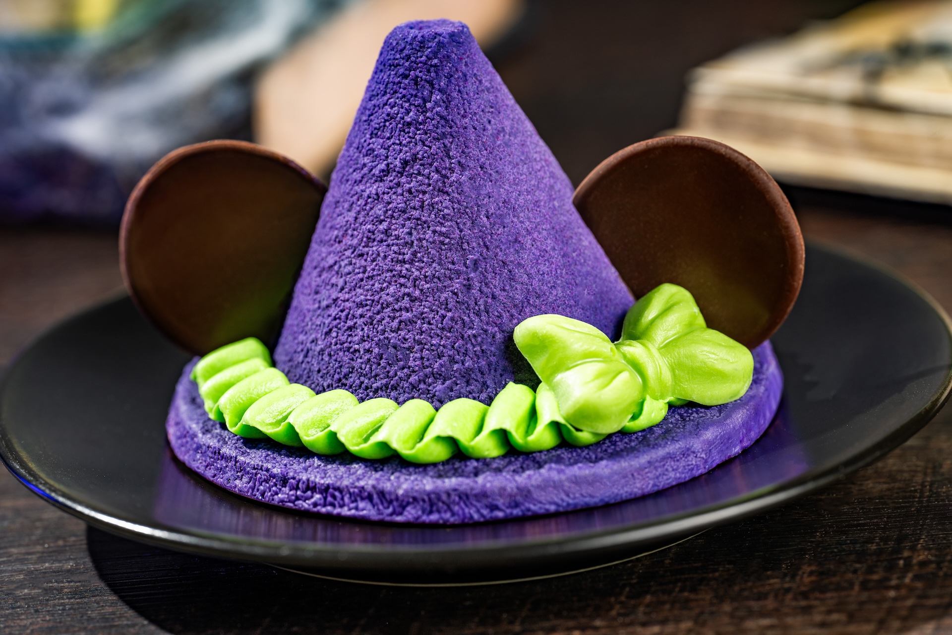 Minnie Witch Hat: Sugar cookie topped with strawberry-banana mousse, chocolate, and buttercream (Available during Mickey&rsquo;s Not-So-Scary Halloween Party only)