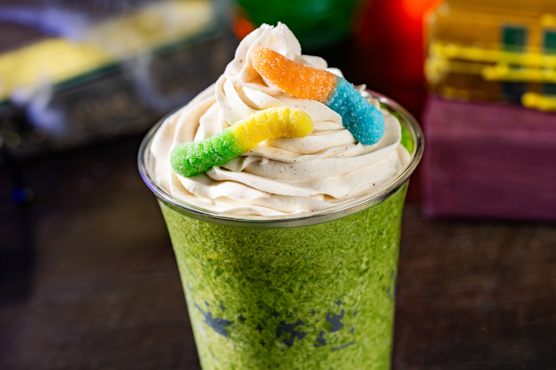 Oogie Boogie Slushy: Frozen apple cider topped with cinnamon whipped cream and sour gummy candy (Non-alcoholic) (Available during Mickey&rsquo;s Not-So-Scary Halloween Party only)