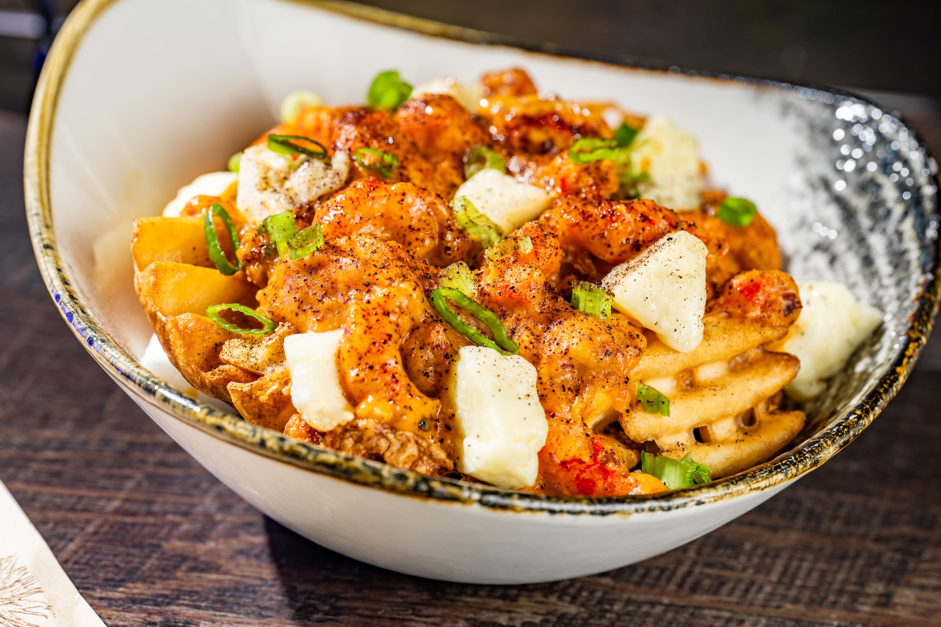 Cajun Crawfish and Sausage BOOtine: Waffle fries topped with cheese curds and Cajun crawfish-andouille sausage gravy (Available during Mickey&rsquo;s Not-So-Scary Halloween Party only)