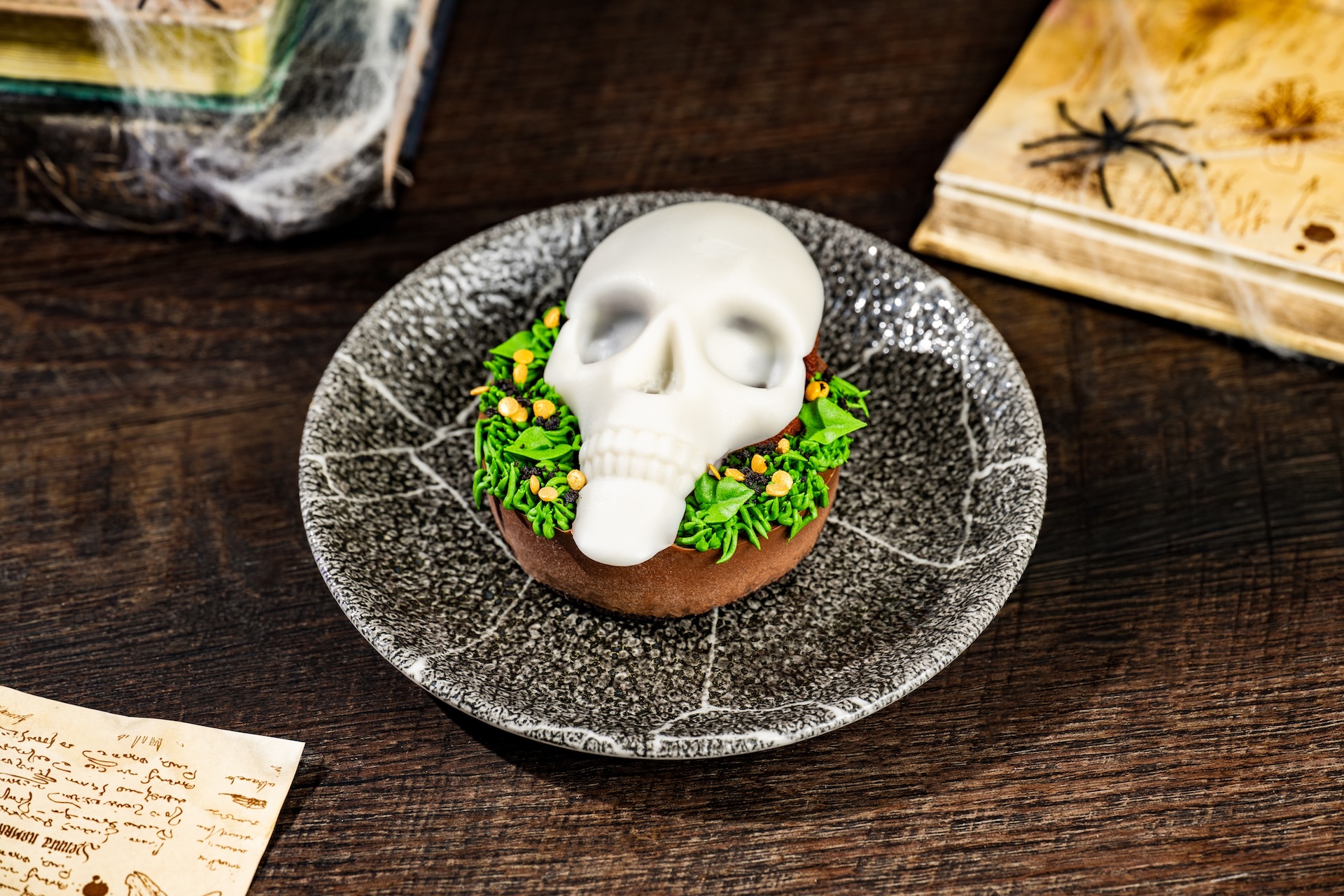 Skull-icious Cake: Chocolate cake, chocolate mousse and peanut butter buttercream with chocolate popping candies and a chocolate cookie crust (New) (Available during Mickey&rsquo;s Not-So-Scary Halloween Party only) 