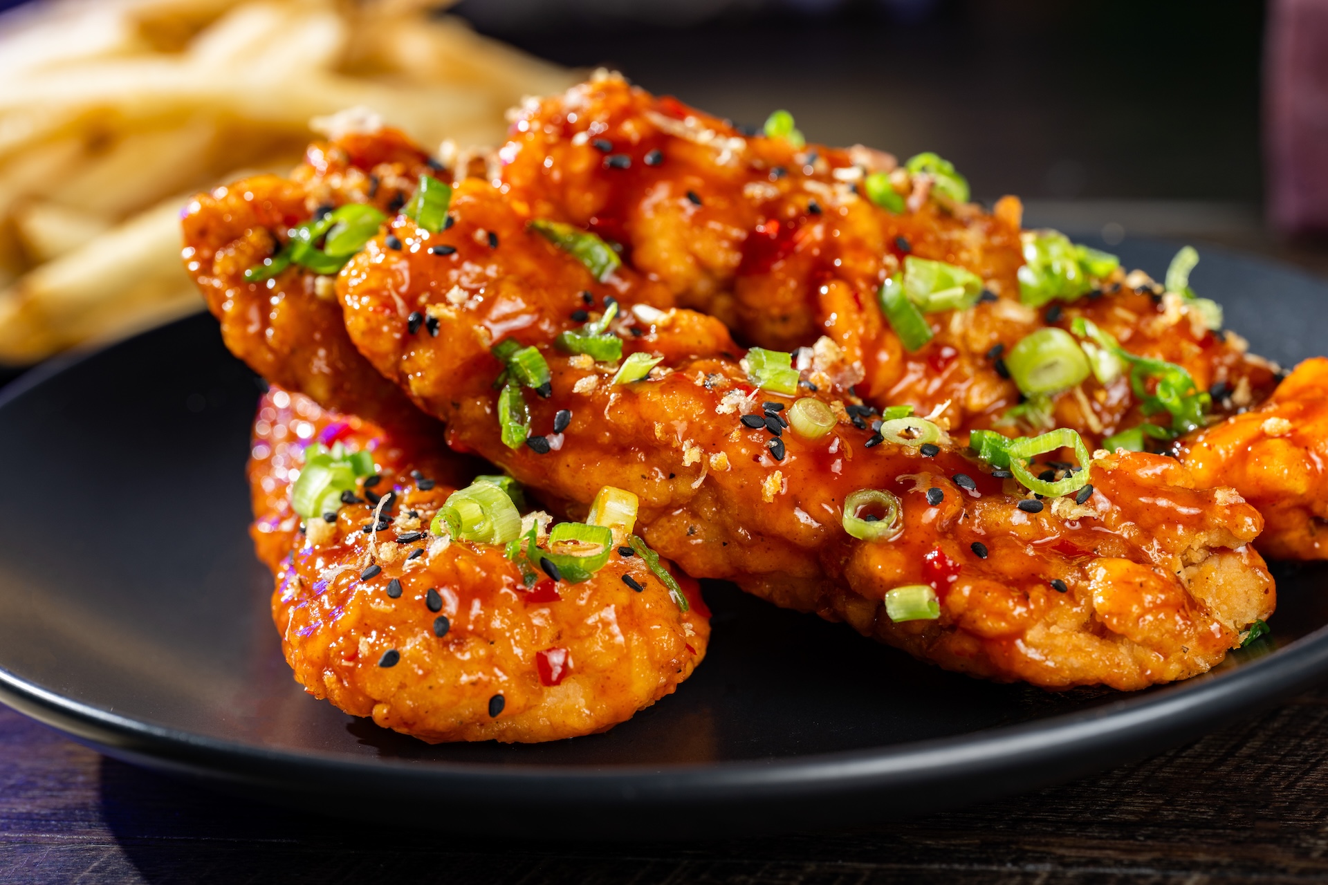 Sweet-and-Spicy Chicken Strips with Korean barbecue sauce and topped with black sesame seeds, crispy garlic, and green onions served with french fries (Available during Mickey&rsquo;s Not-So-Scary Halloween Party only)