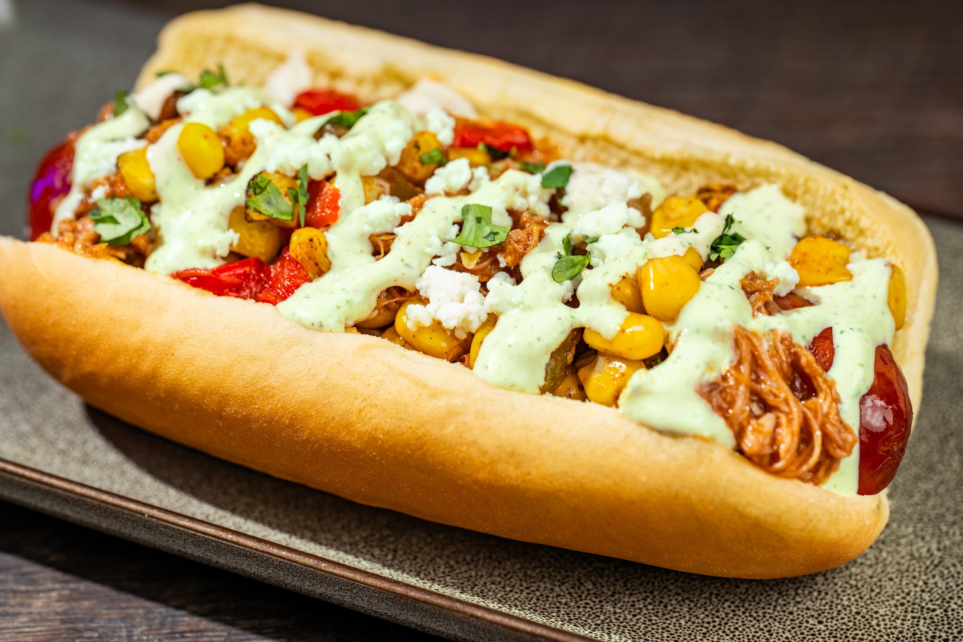 Chipotle Barbecue Pork and Street Corn Hot Dog: All-beef hot dog topped with fire-roasted corn, queso fresco, jalape&ntilde;o ranch, and cilantro (Available during Mickey&rsquo;s Not-So-Scary Halloween Party only)