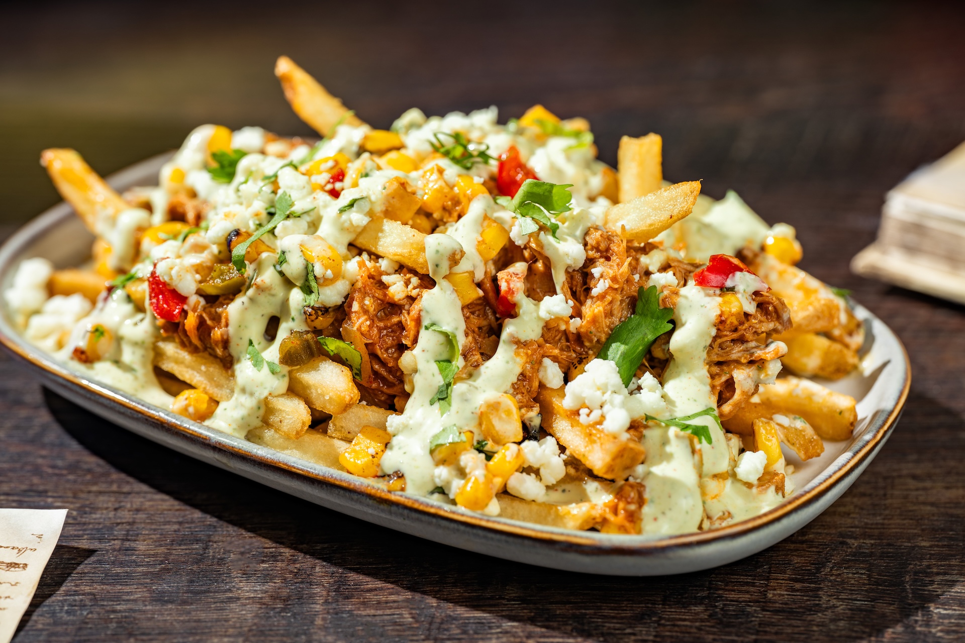Chipotle Barbecue Pork and Street Corn French Fries: French fries topped with fire-roasted corn, queso fresco, jalape&ntilde;o ranch, and cilantro (Available during Mickey&rsquo;s Not-So-Scary Halloween Party only)