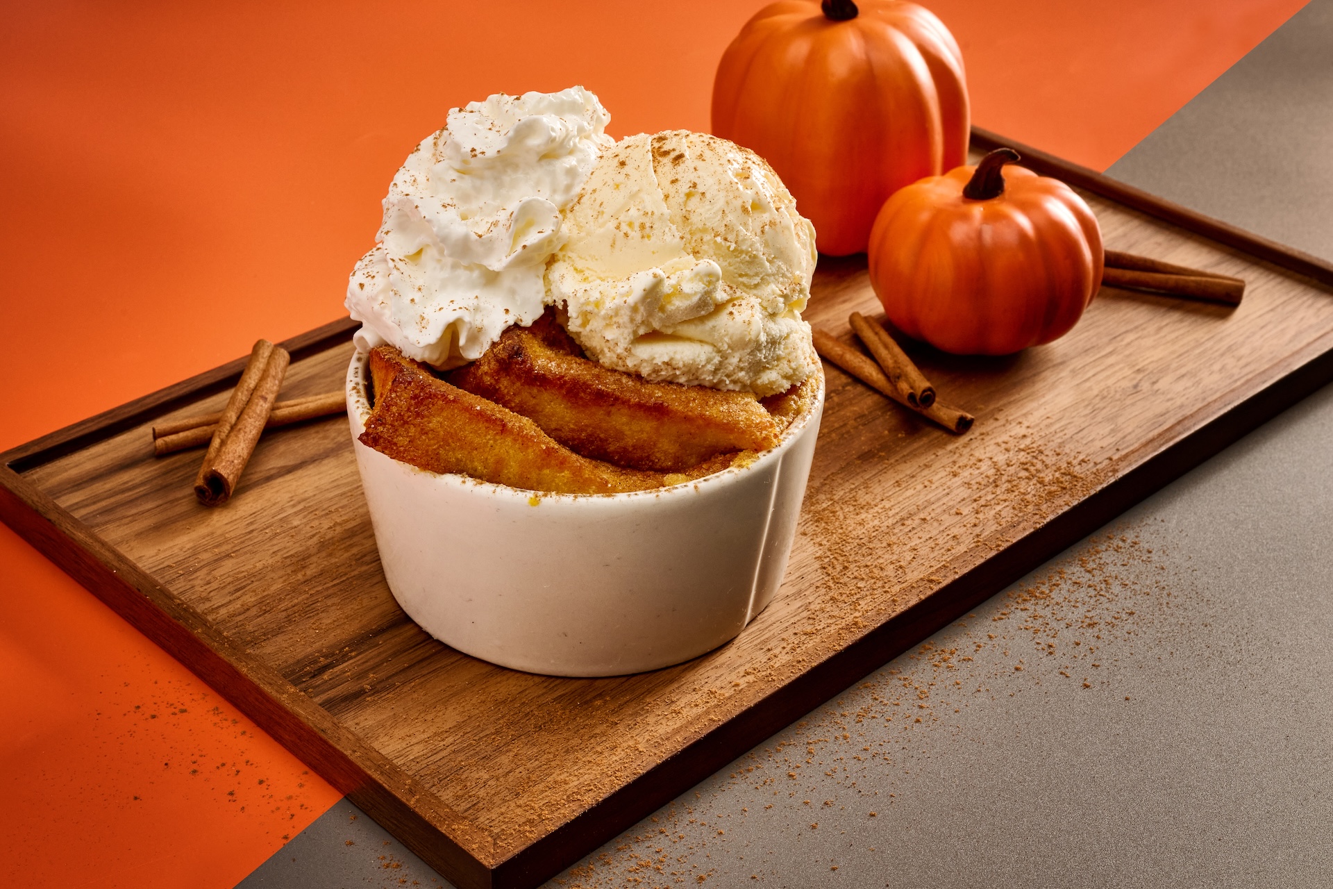Pumpkin Bread Pudding topped with vanilla ice cream, house made whipped cream, and a dusting of pumpkin spice cinnamon blend