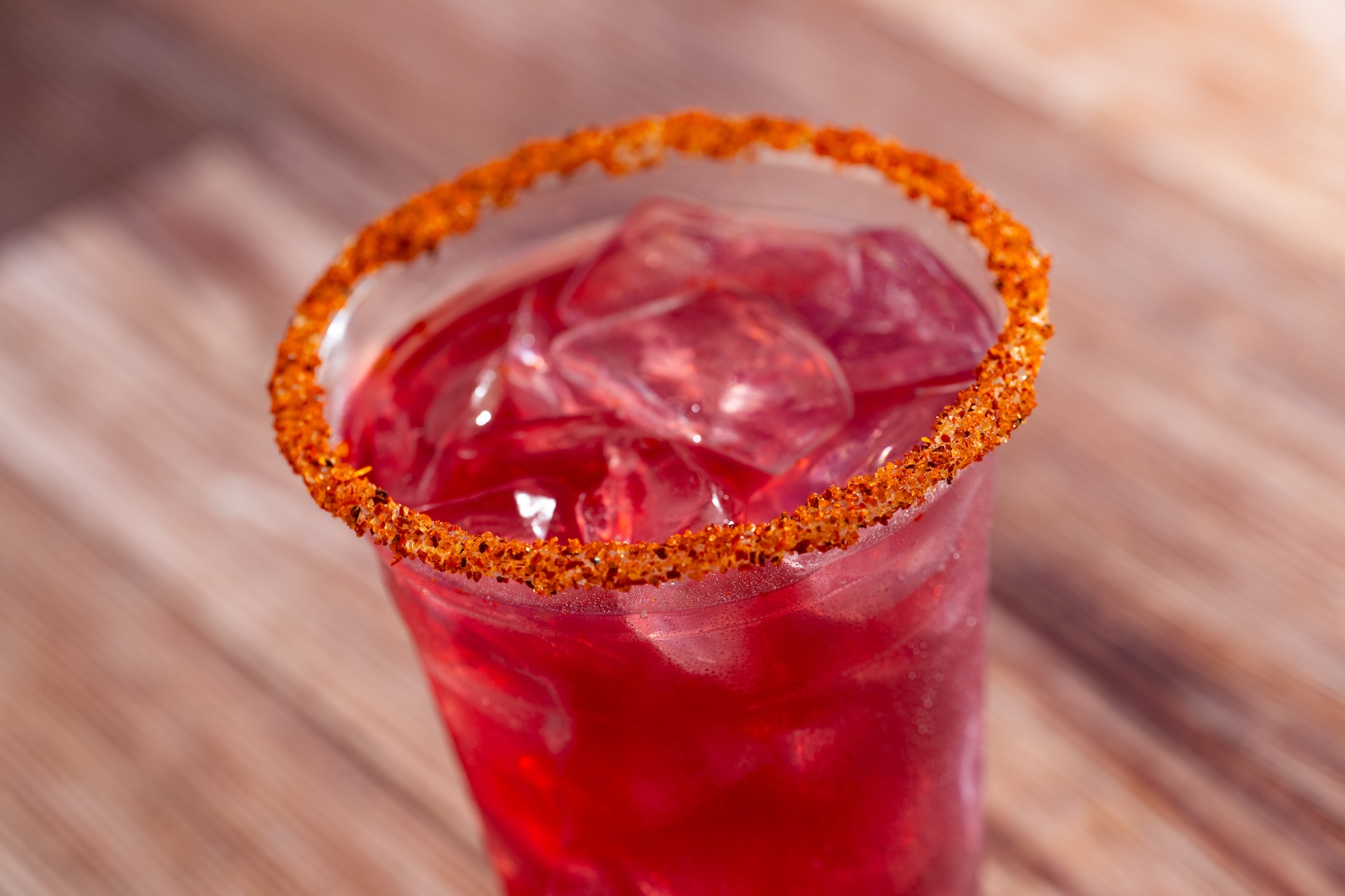 Hibiscus Mezcal Margarita: Del Maguey Vida Mezcal, Cointreau Liqueur, sour mix, lime juice, and hibiscus syrup garnished with chili-lime seasoning (New)