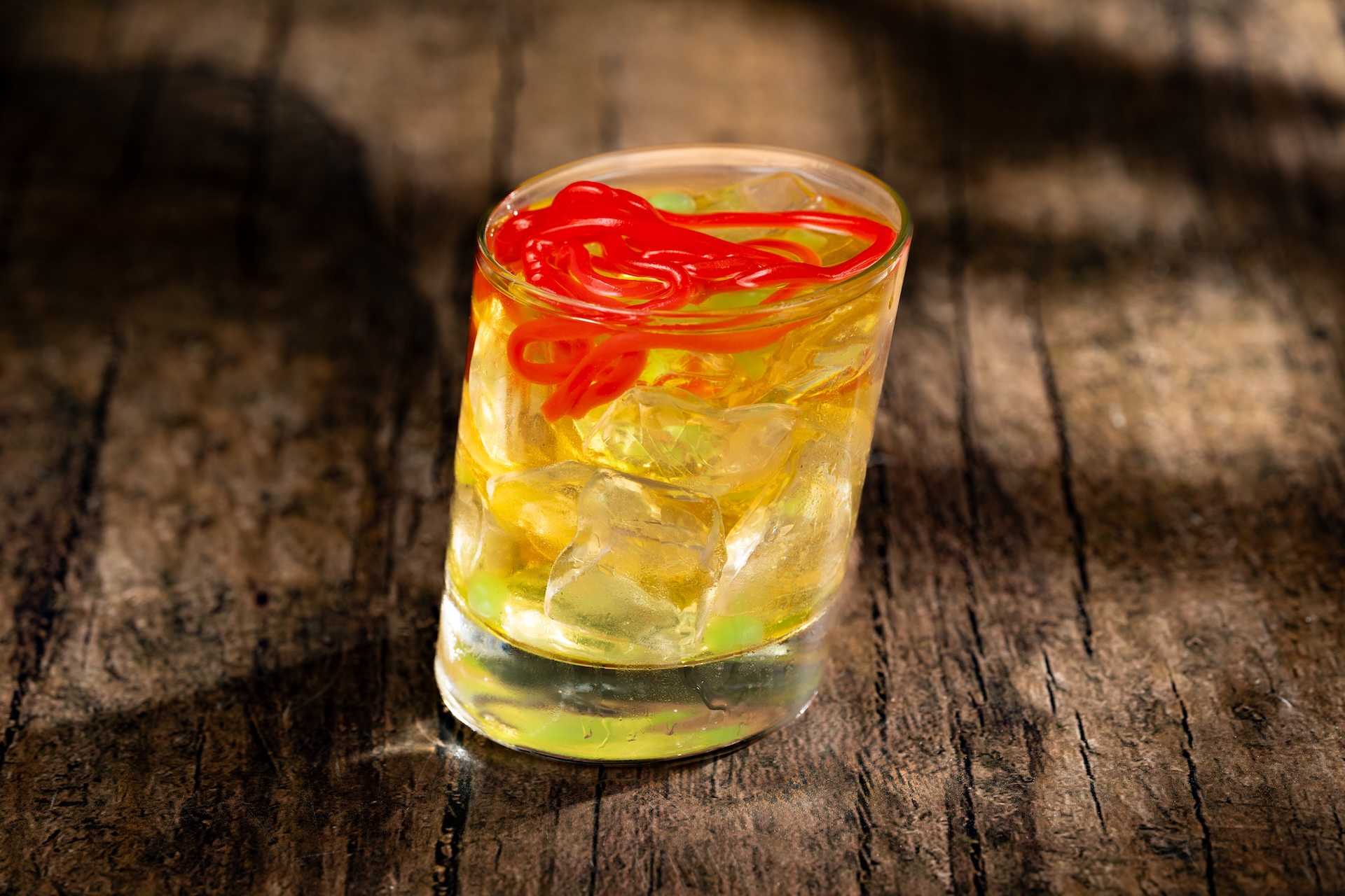 Skull and Sour: Jameson Irish Whiskey, Bols Peach Schnapps Liqueur, lemon juice, and pumpkin spice syrup topped with green apple juice-filled pearls and gummy strands (New)