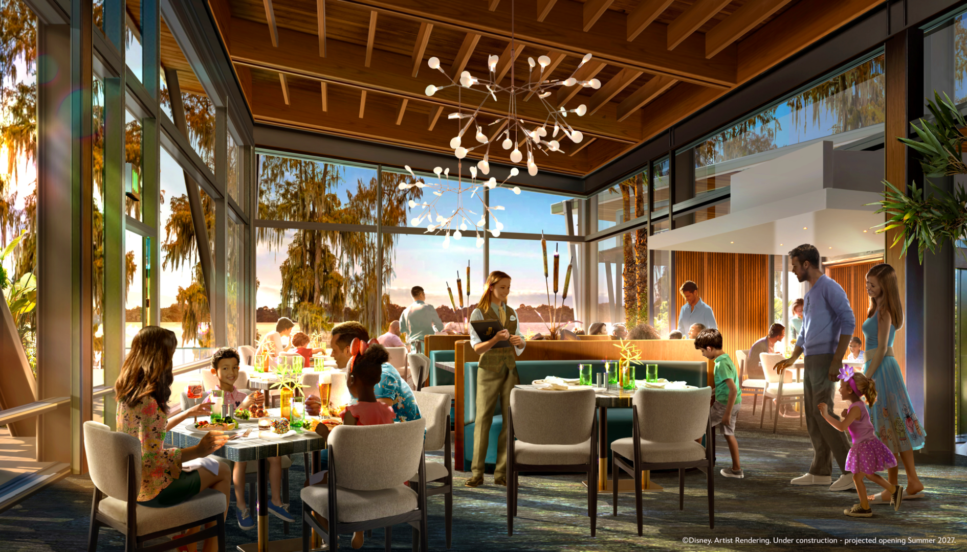 Bright restaurant interior with families dining and a server taking orders.
