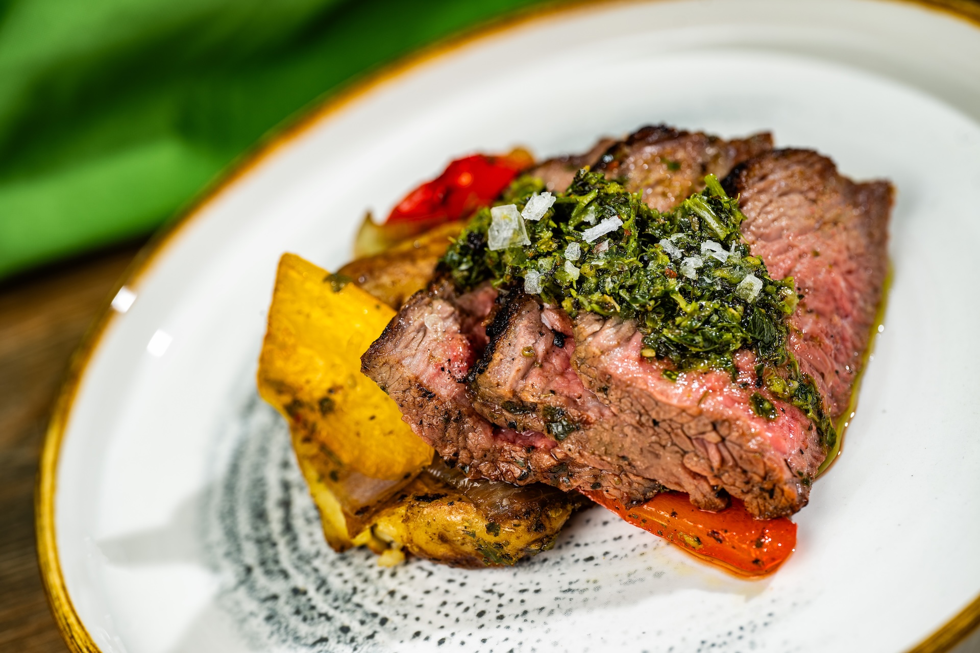 Rodizio-style Grilled Beef Skewer with marble potatoes, charred shallots, roasted baby peppers, and chimichurri (Introduced in 2009 at Argentina)  