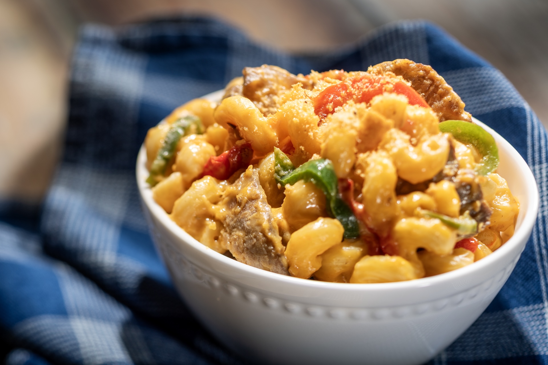 🧀Cheesesteak Macaroni and Cheese with smoked cheddar sauce, shaved beef, peppers, onions, and herbed panko  