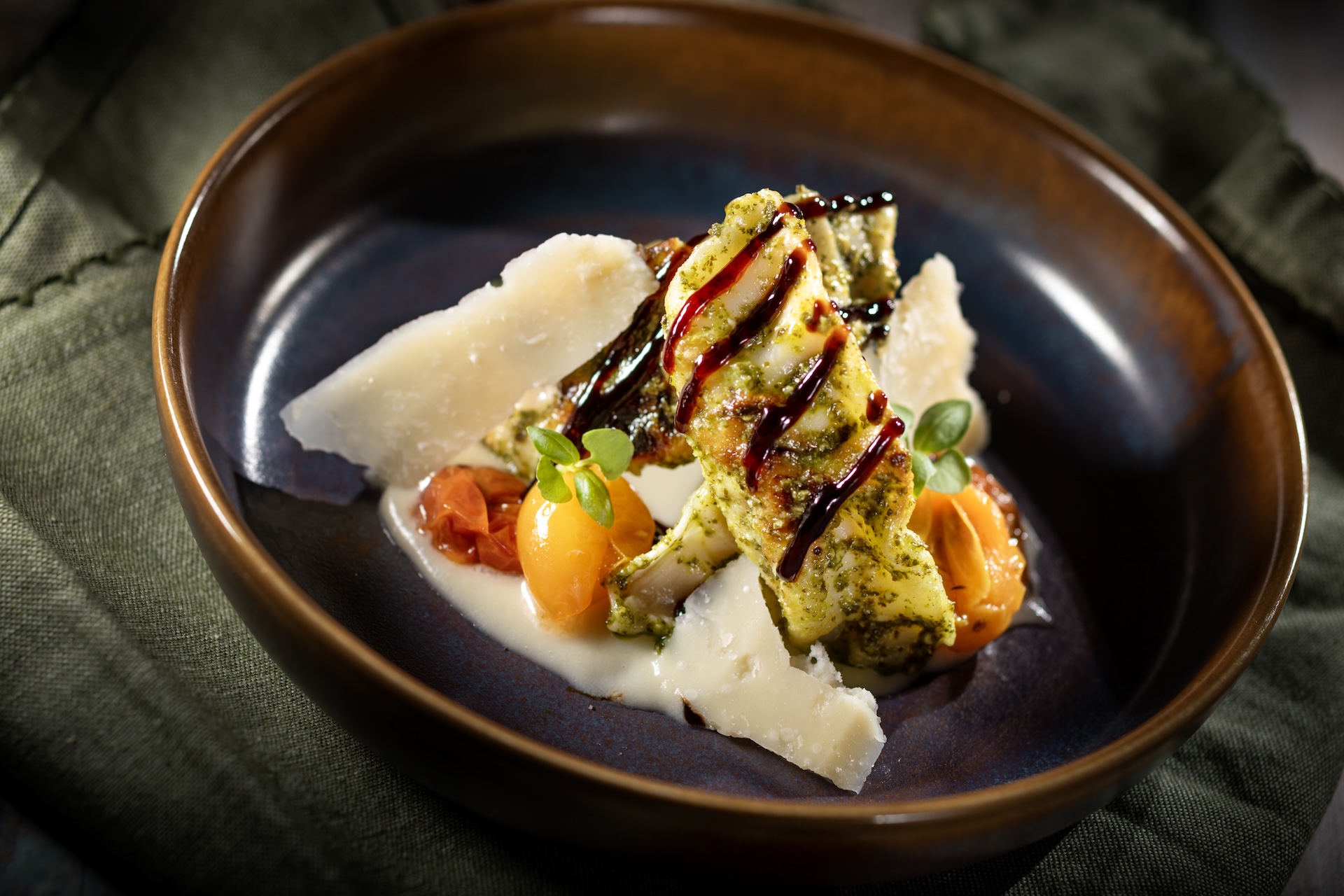 Basil Pesto Chicken Dumplings: Chicken dumplings, basil pesto, fonduta, tomato confit, and balsamic