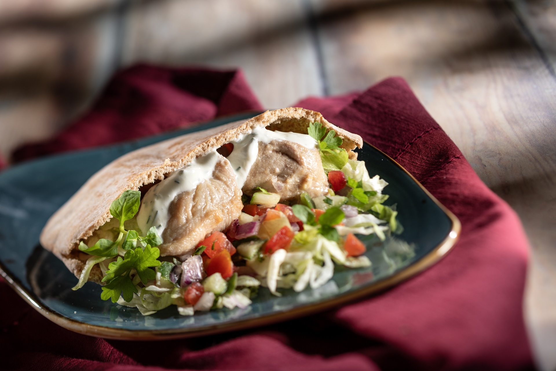 Chicken Souvlaki Gyro with shaved lettuce, tomato-cucumber relish, and tzatziki on warm pita (Introduced in 1997) (New)  