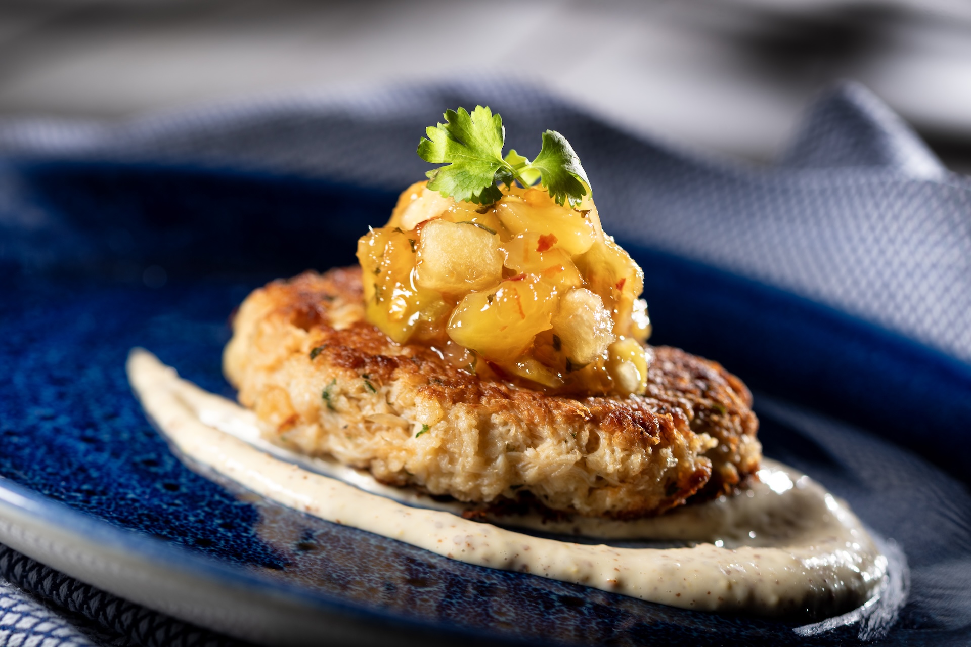 Crab Cake with tropical fruit chutney, mustard sauce, and micro celery  