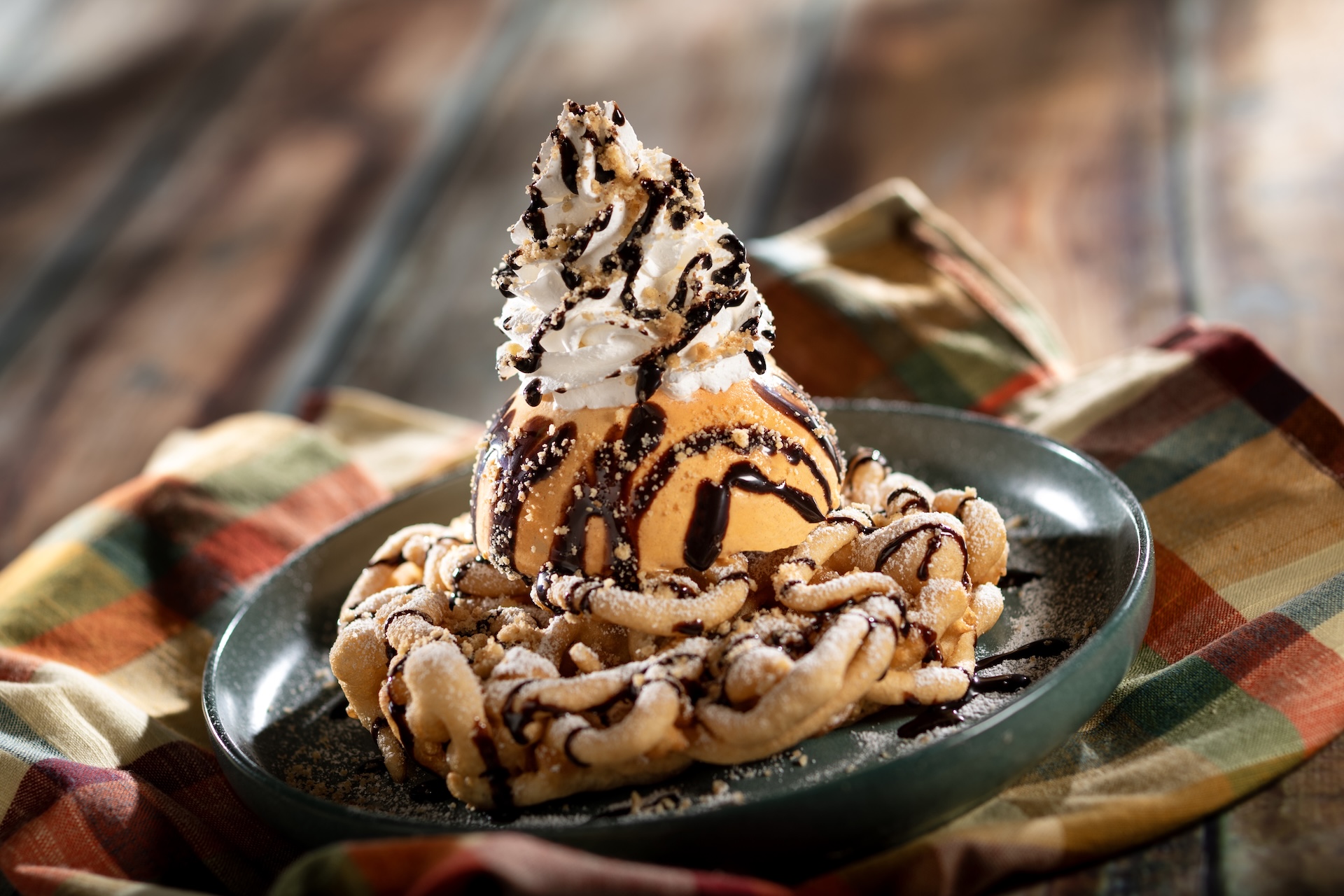 Pumpkin Pie Funnel Cake: Funnel cake with pumpkin pie ice cream, whipped cream, dark chocolate sauce, cinnamon streusel, and powdered sugar (New) 