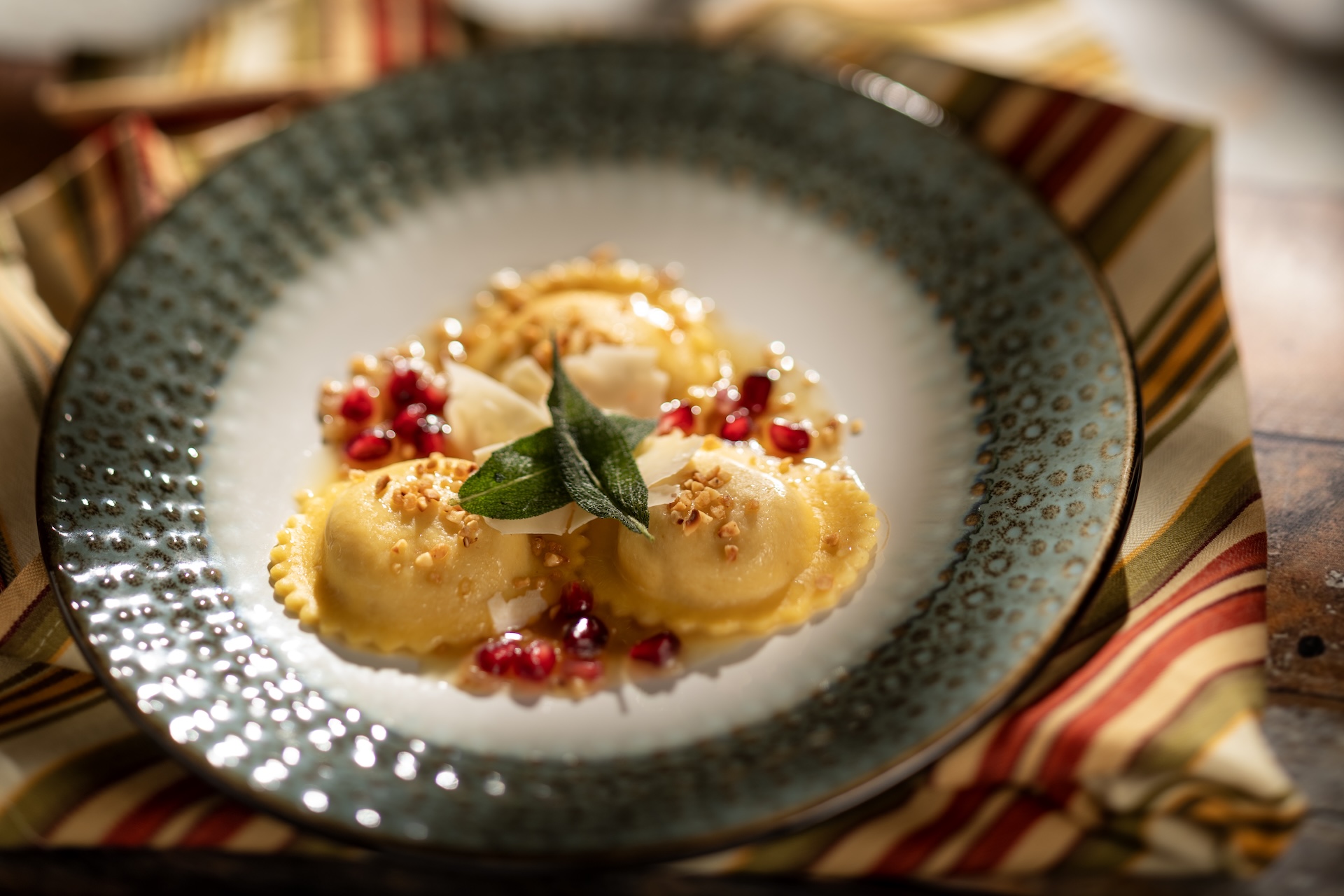 🧀 Pumpkin-Mascarpone Ravioli with brown butter vinaigrette, pecorino cheese, pomegranate seeds, and hazelnut praline  