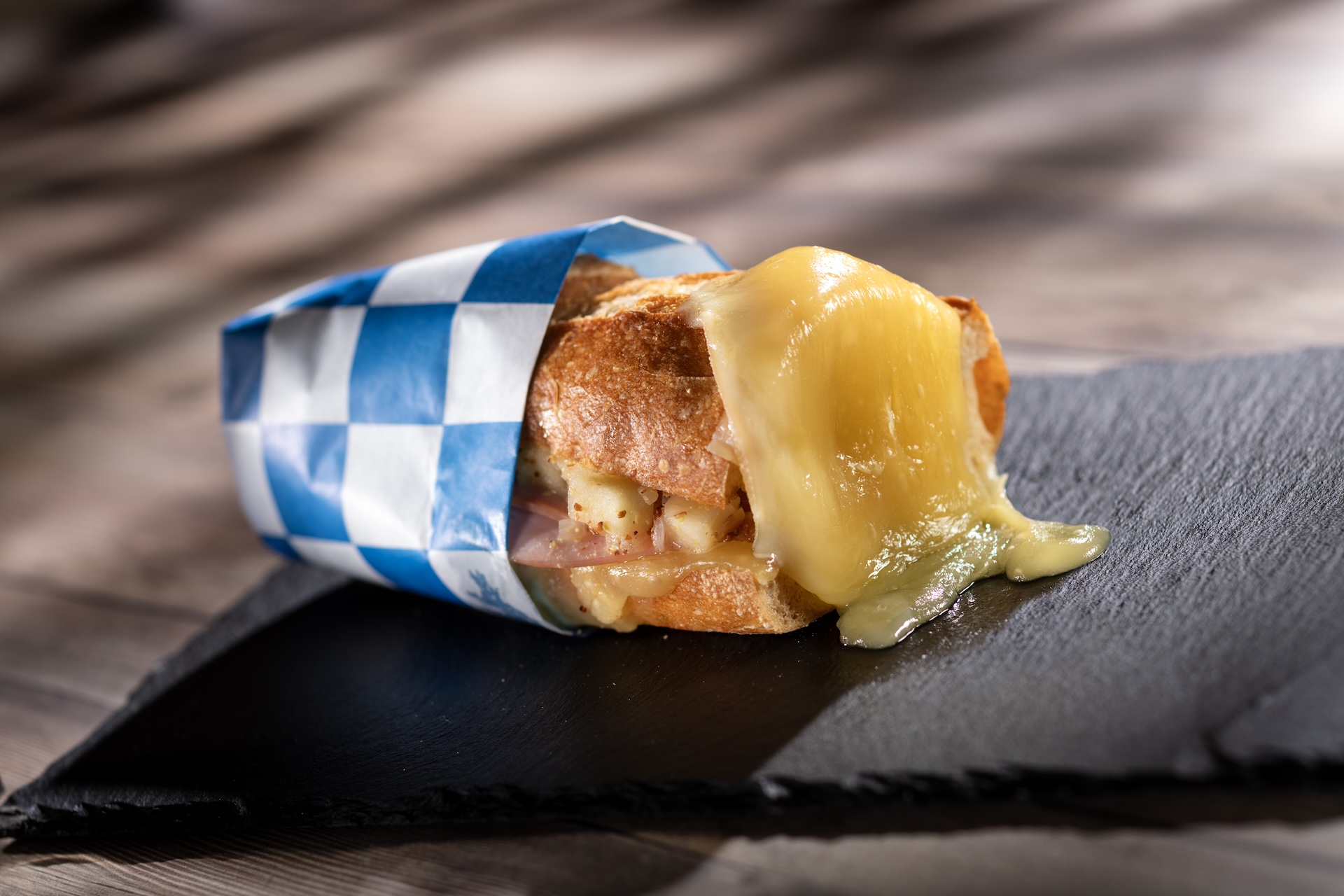 🧀 Warm Raclette Swiss Cheese on a baguette with jambon and apple-mustard relish (Introduced in 1997) (New)  