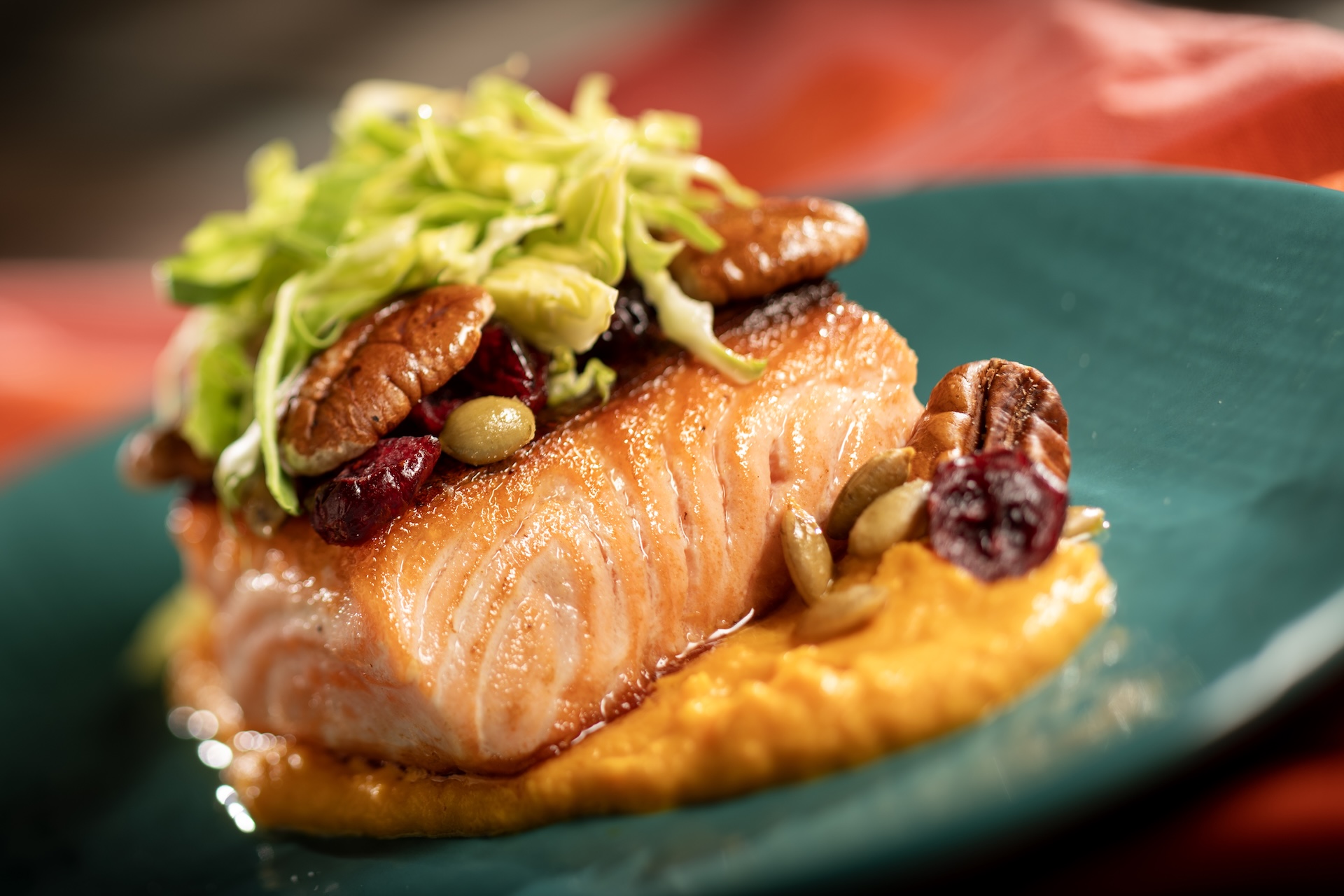 Cast Iron-seared River Trout with vanilla-butternut squash pur&eacute;e, Brussels sprouts salad, candied pecans, spiced pumpkin seeds, dried cranberries, and maple dressing  