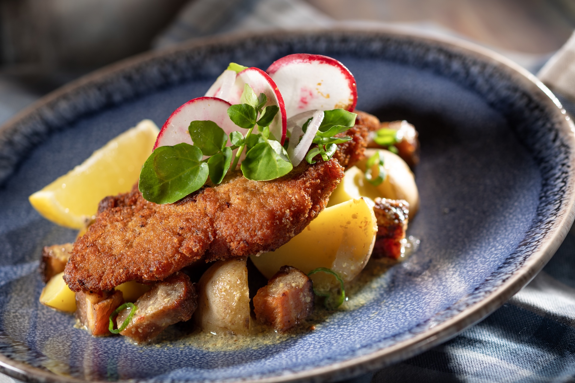 Wiener Schnitzel with breaded veal cutlet featuring HEINZ Brauhaus Mustard, warm Yukon Gold potato salad, bacon, watercress-radish salad, and lemon (New)  