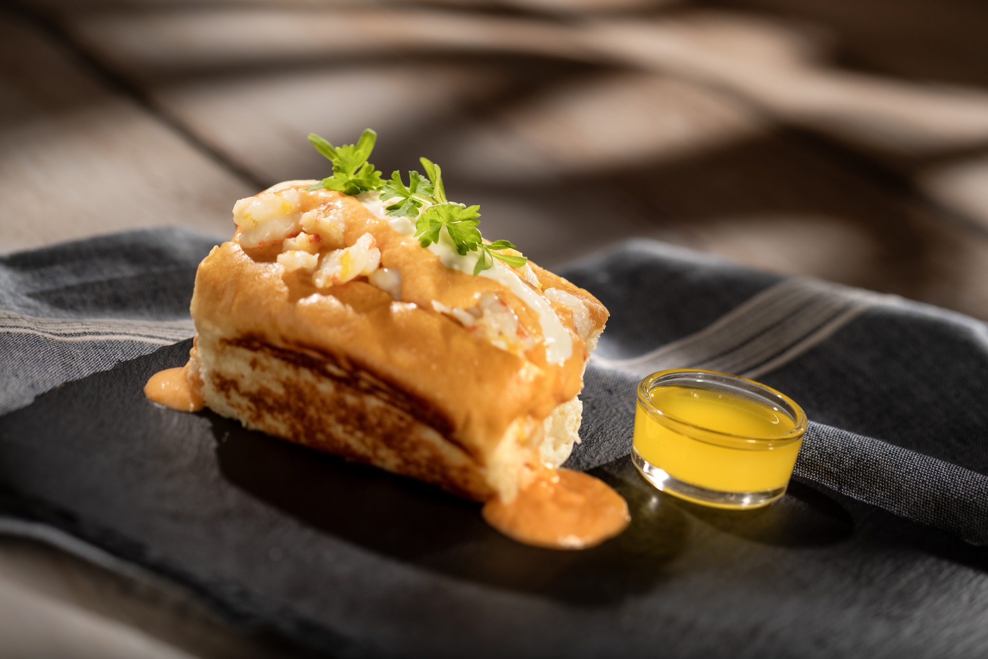 Gulf Coast-style Seafood Roll with warm-water lobster, rock shrimp, lobster bisque, and sherry cr&egrave;me fra&icirc;che on a toasted brioche bun (Introduced in 2006)  