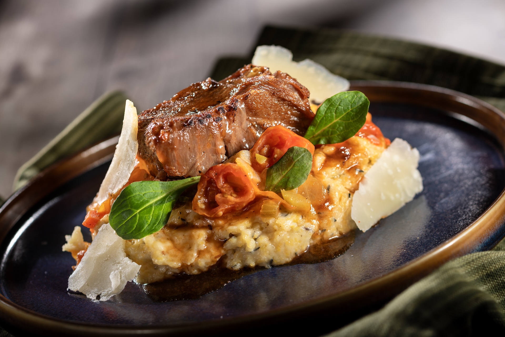 🧀 Red Wine-braised Beef Short Rib with goat cheese polenta, tomato rag&ugrave;, shaved pecorino cheese, and petit herbs 