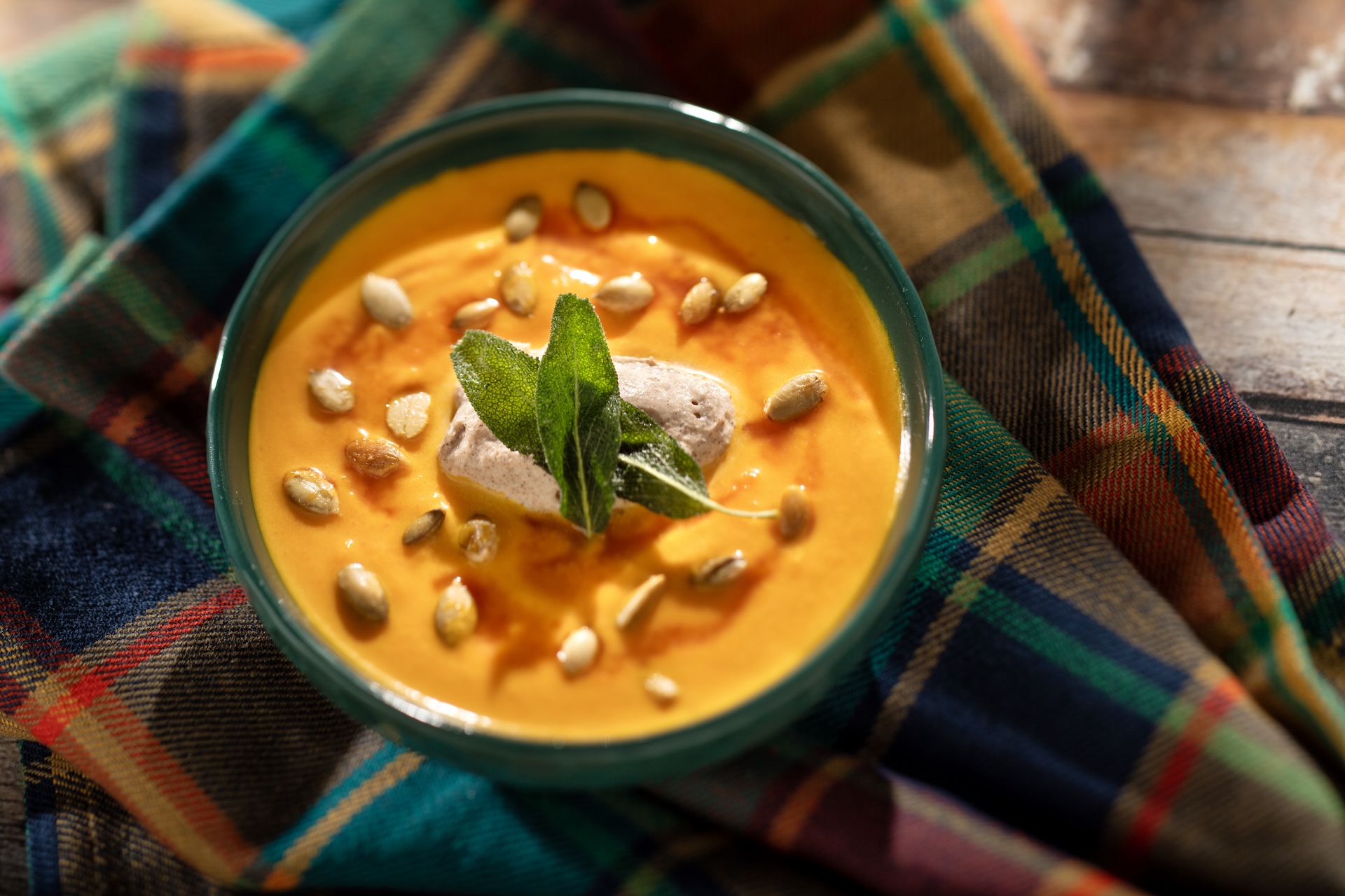 Butternut Squash and Ginger Bisque with cinnamon cream, toasted pumpkin seeds, and pumpkin seed oil  