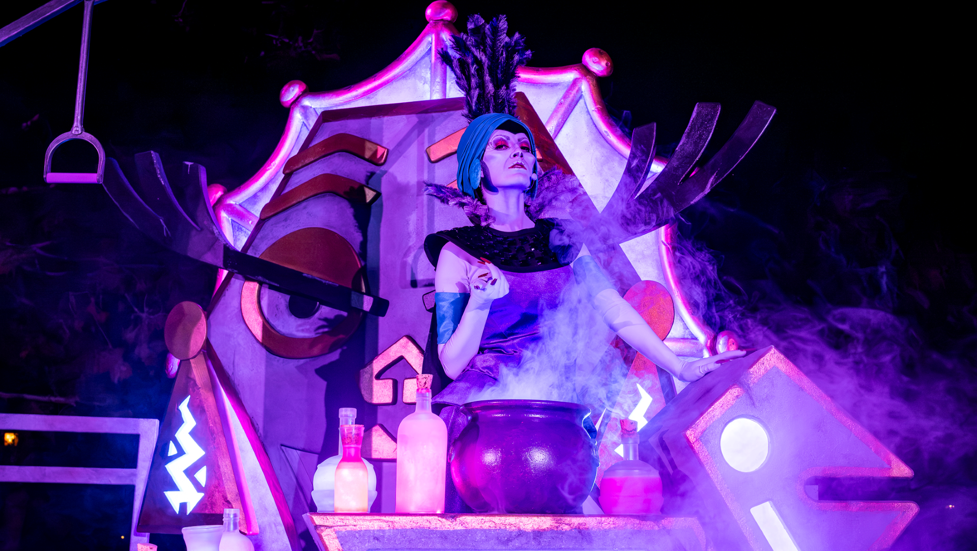Yzma, surrounded by potions, casts spells in colorful smoke.