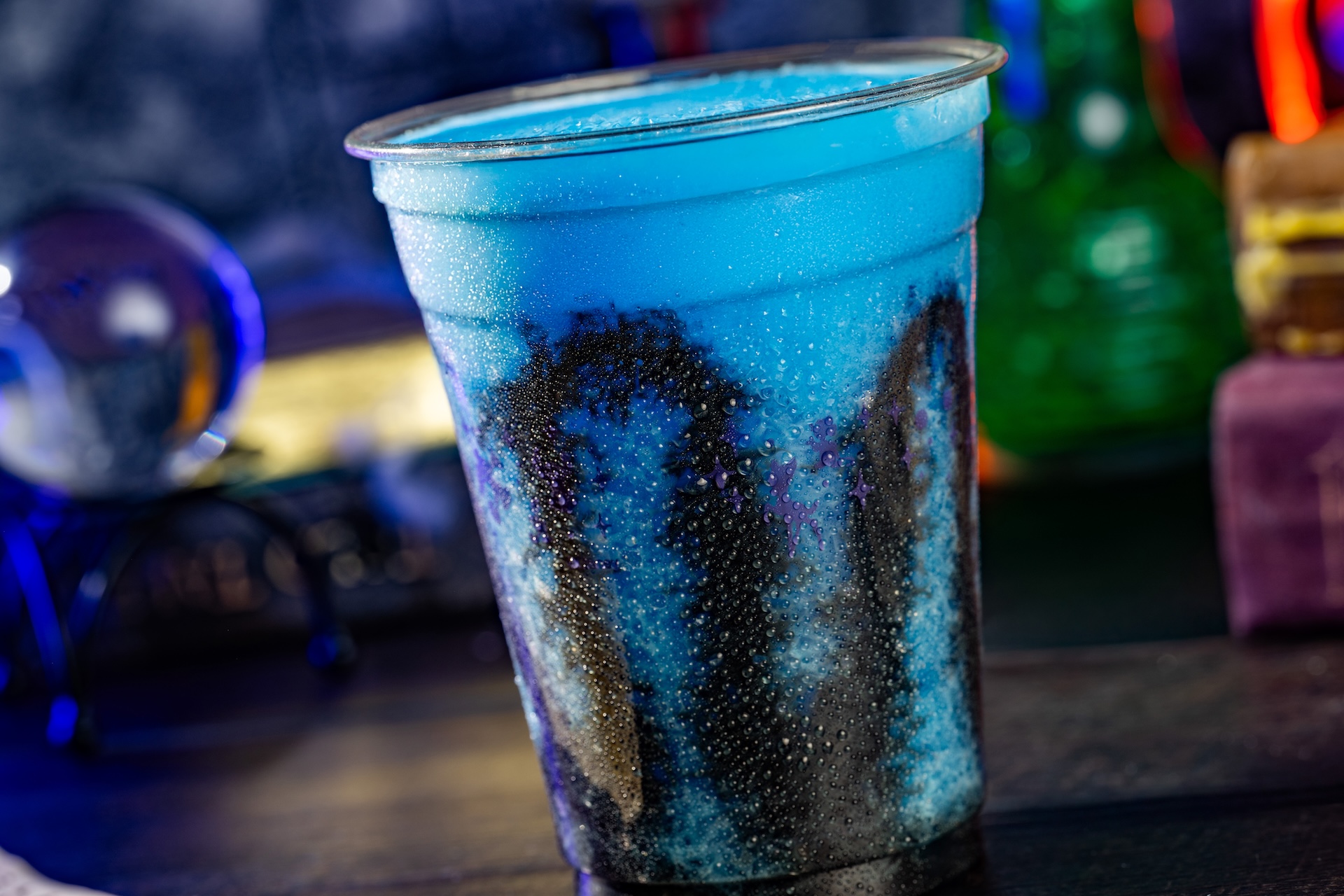 Ghoulish Blue Raspberry Slushy: Fanta Blue Raspberry Slushy with black vanilla drizzle (Non-alcoholic)  