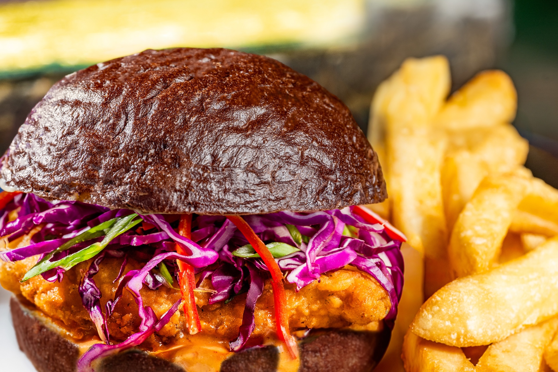 Devilish Crispy Chicken Sandwich: Ghoulish spiced mayonnaise, red cabbage, and Fresno peppers on a black kaiser roll served with french fries (New) 