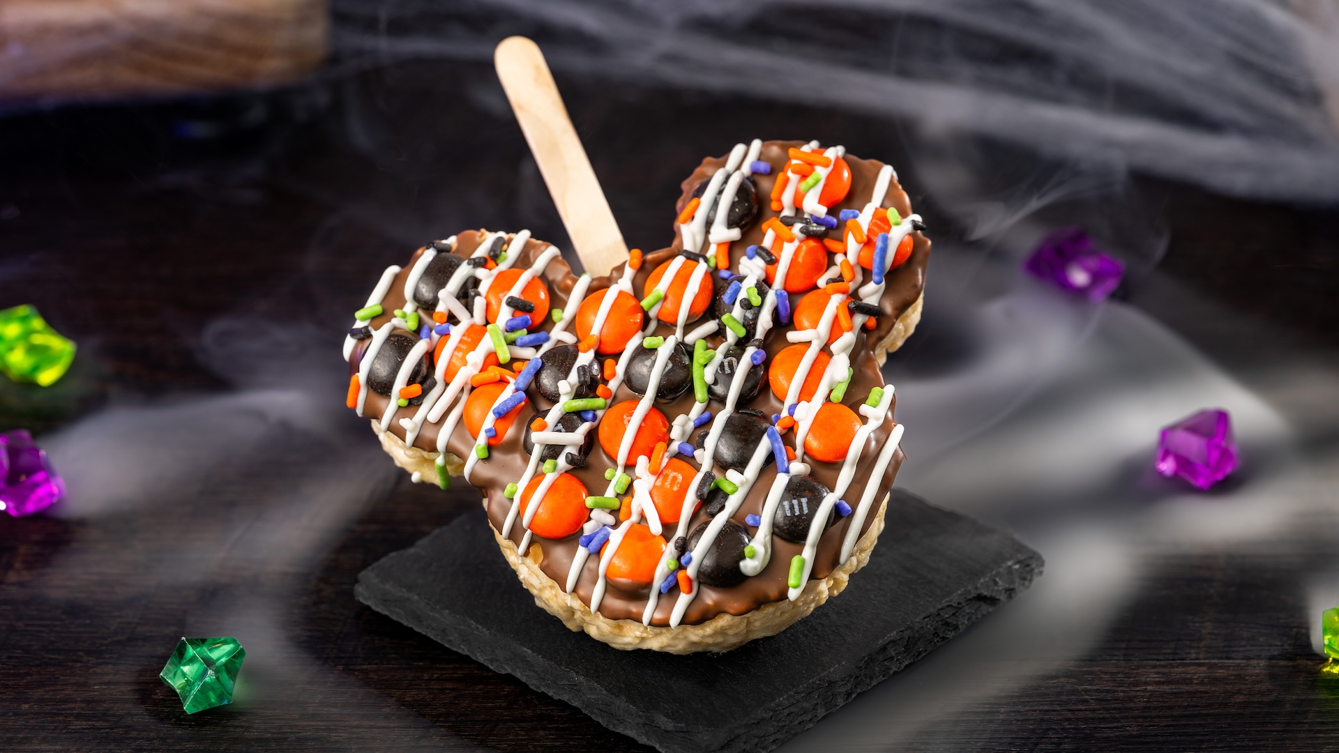 Mickey Halloween Cereal Treat with M&M&rsquo;S Milk Chocolate Candies: Crisped rice cereal treat with milk chocolatey coating, M&M'S milk chocolate candies Halloween blend, Halloween sprinkles, and white chocolatey drizzle 