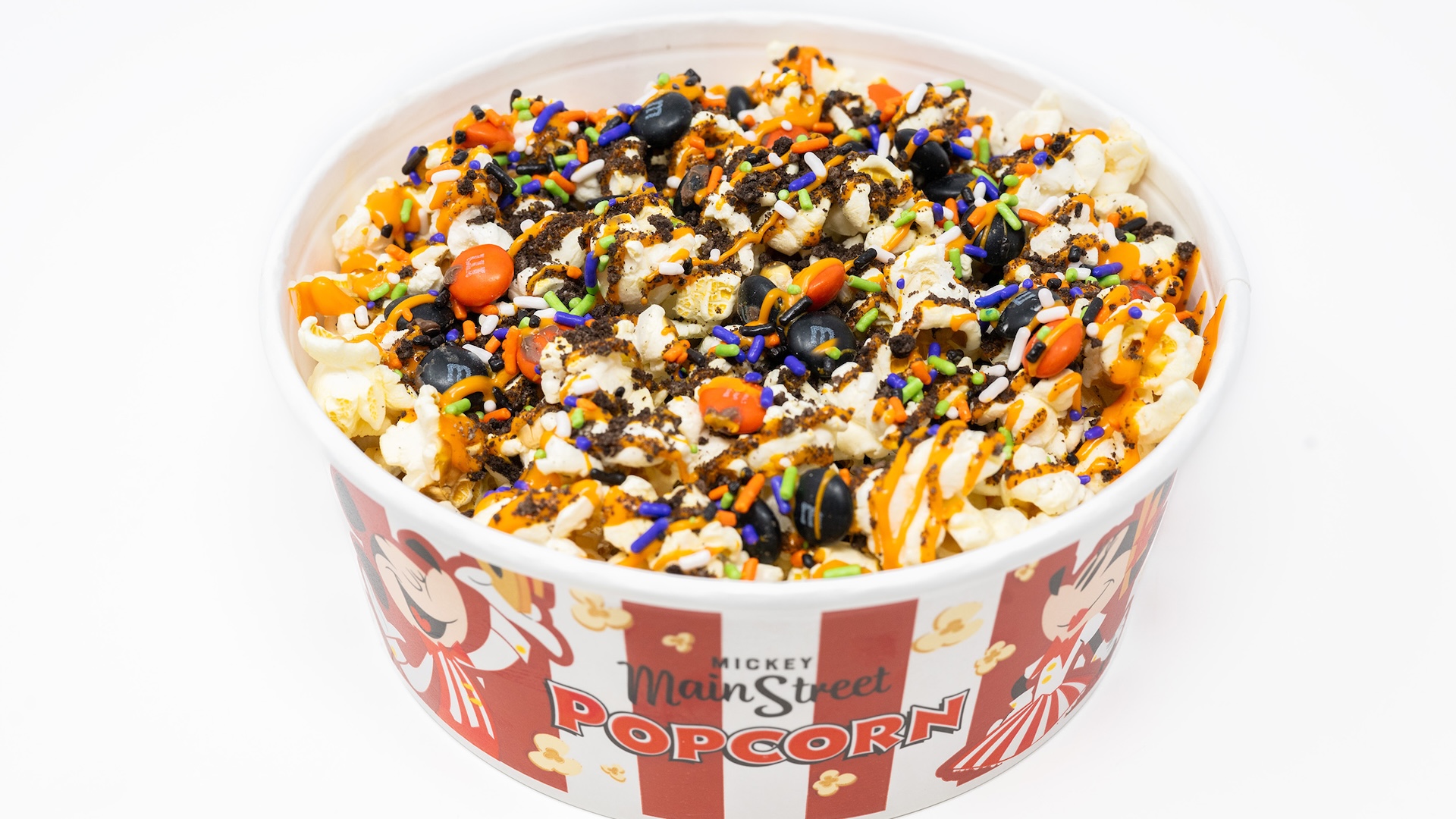 Halloween Treat Popcorn Mix with M&M&rsquo;S Milk Chocolate Candies: Buttered popcorn with M&M&rsquo;S milk chocolate candies Halloween blend, crushed chocolate cookies, Halloween sprinkles, and orange chocolatey drizzle  