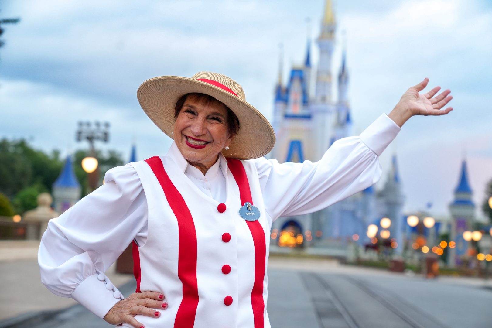 Carol smiling in front of Cinderella's castle.
