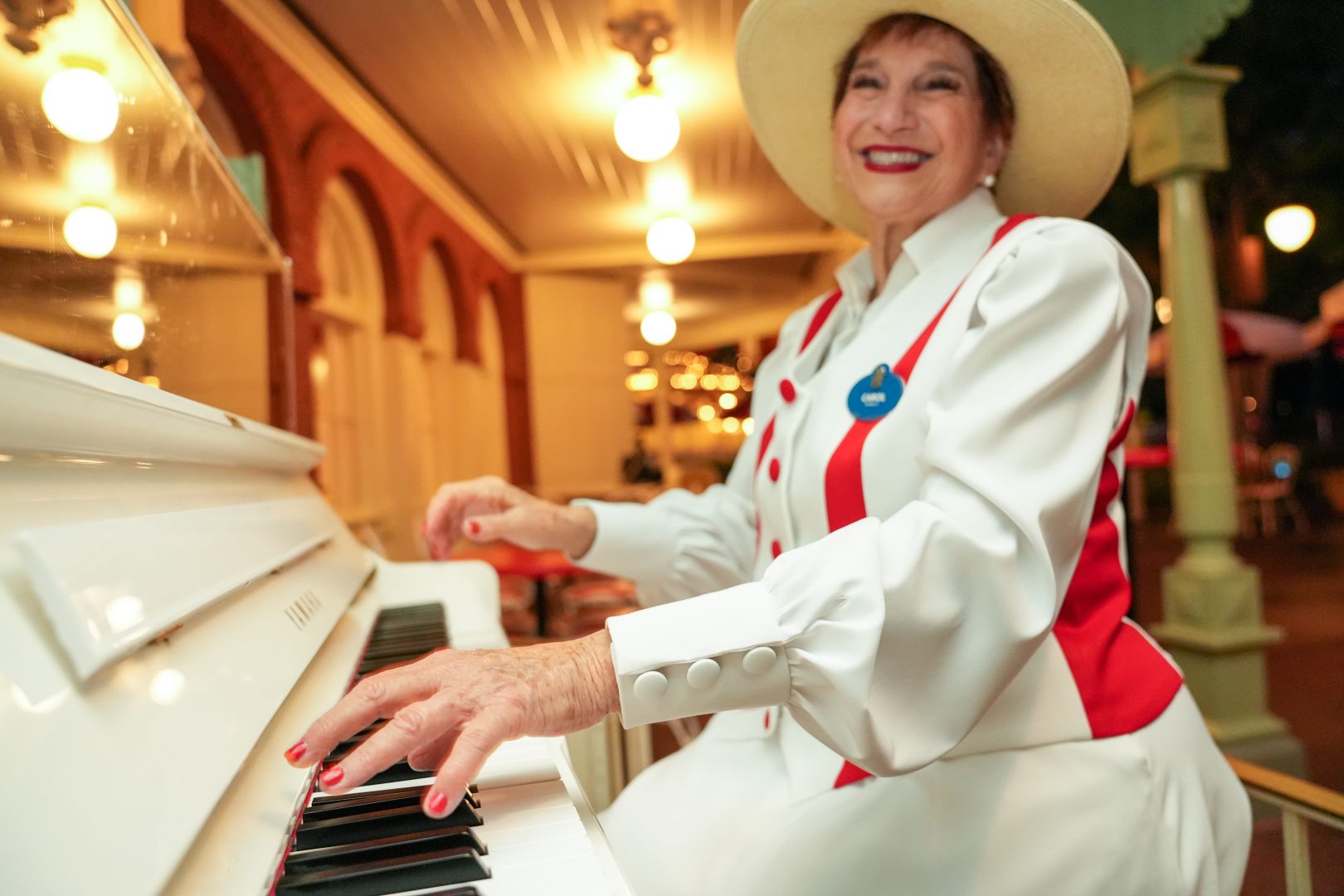 Carol playing piano at Casey's Corner smiling.
