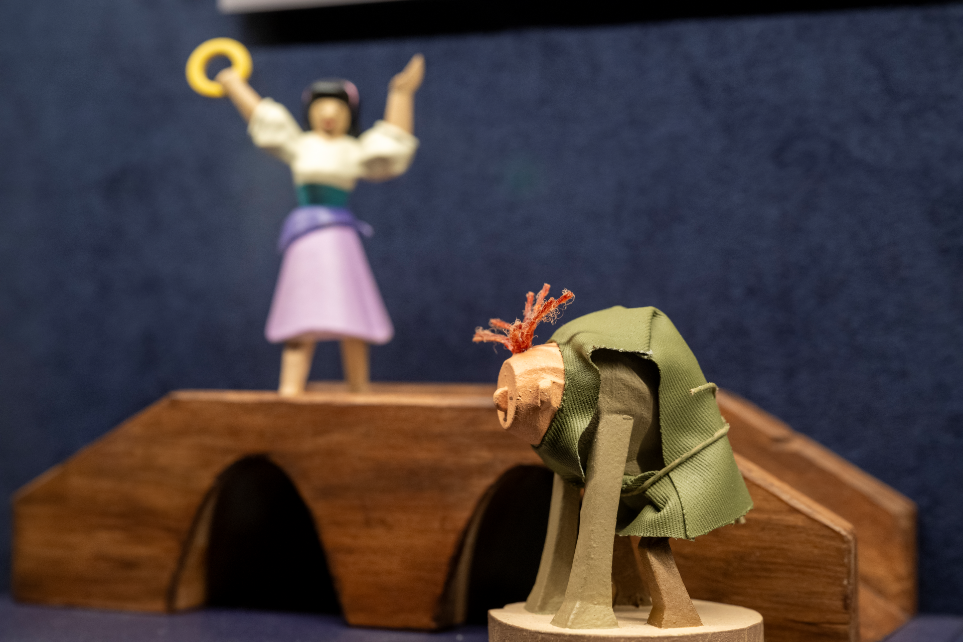 Figurines of characters from 'The Hunchback of Notre Dame' on a stage.