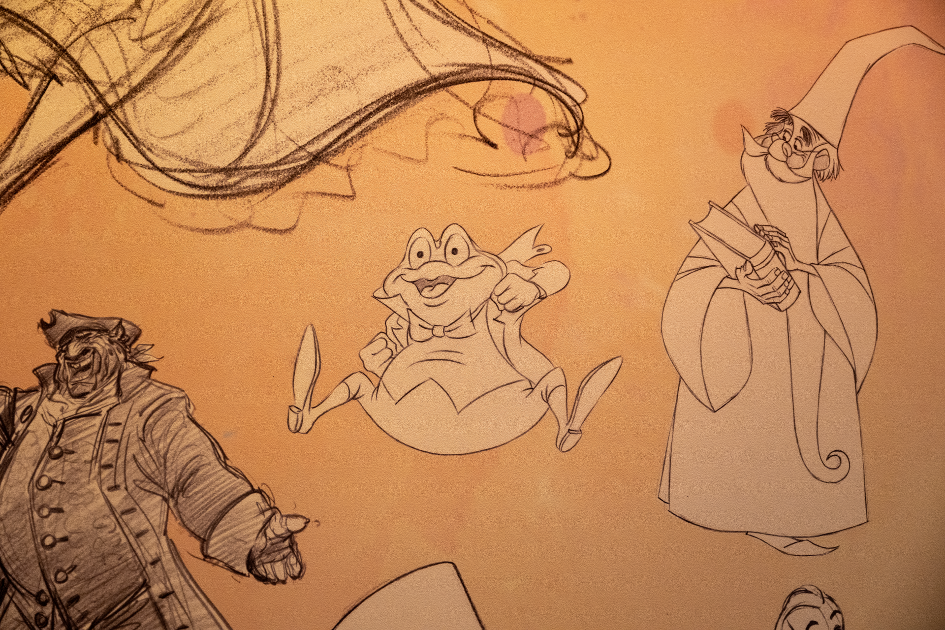 Sketches of animated characters, including Mr. Toad and a wizard.