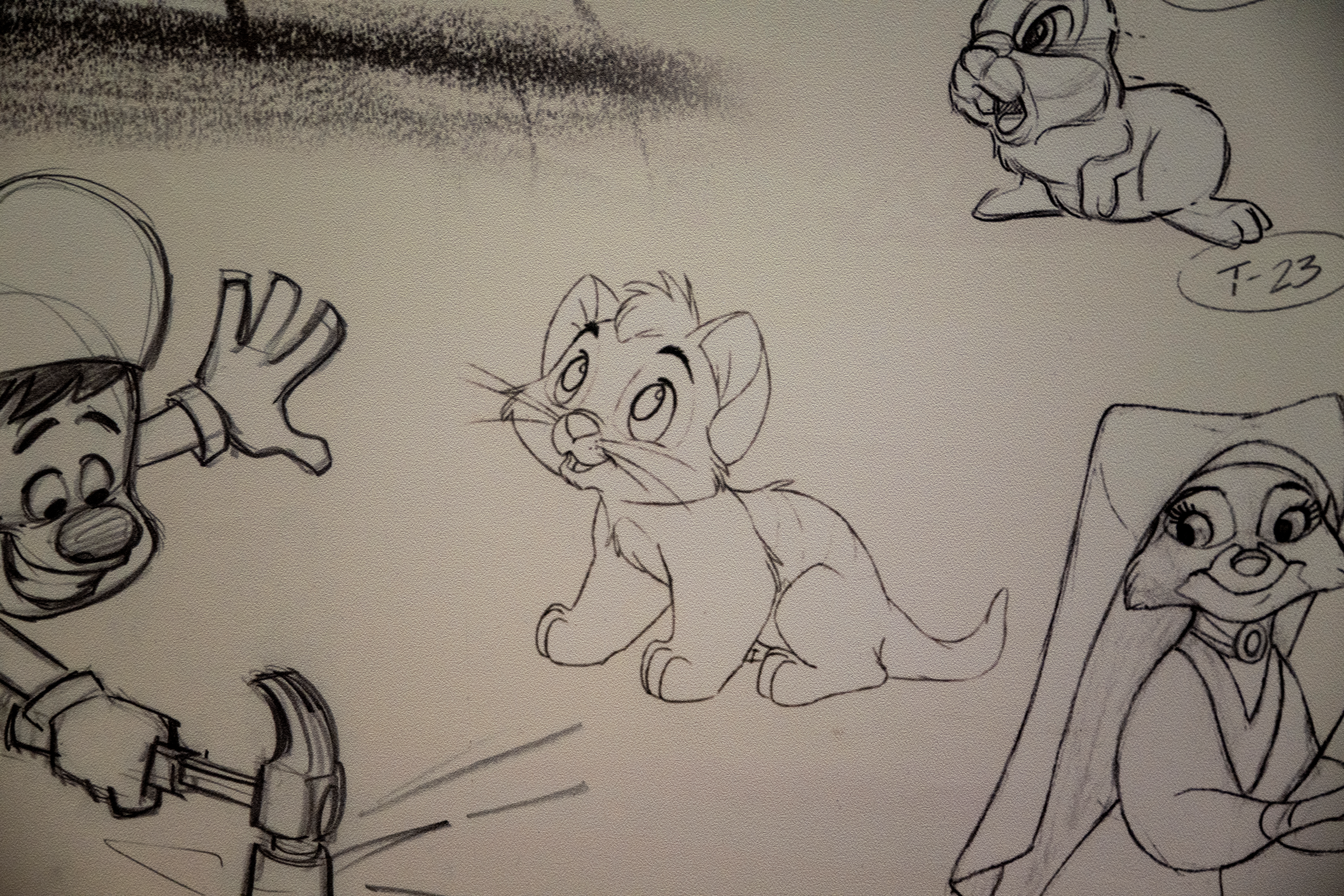 Sketches of animated characters, including a cat and a smiling boy.