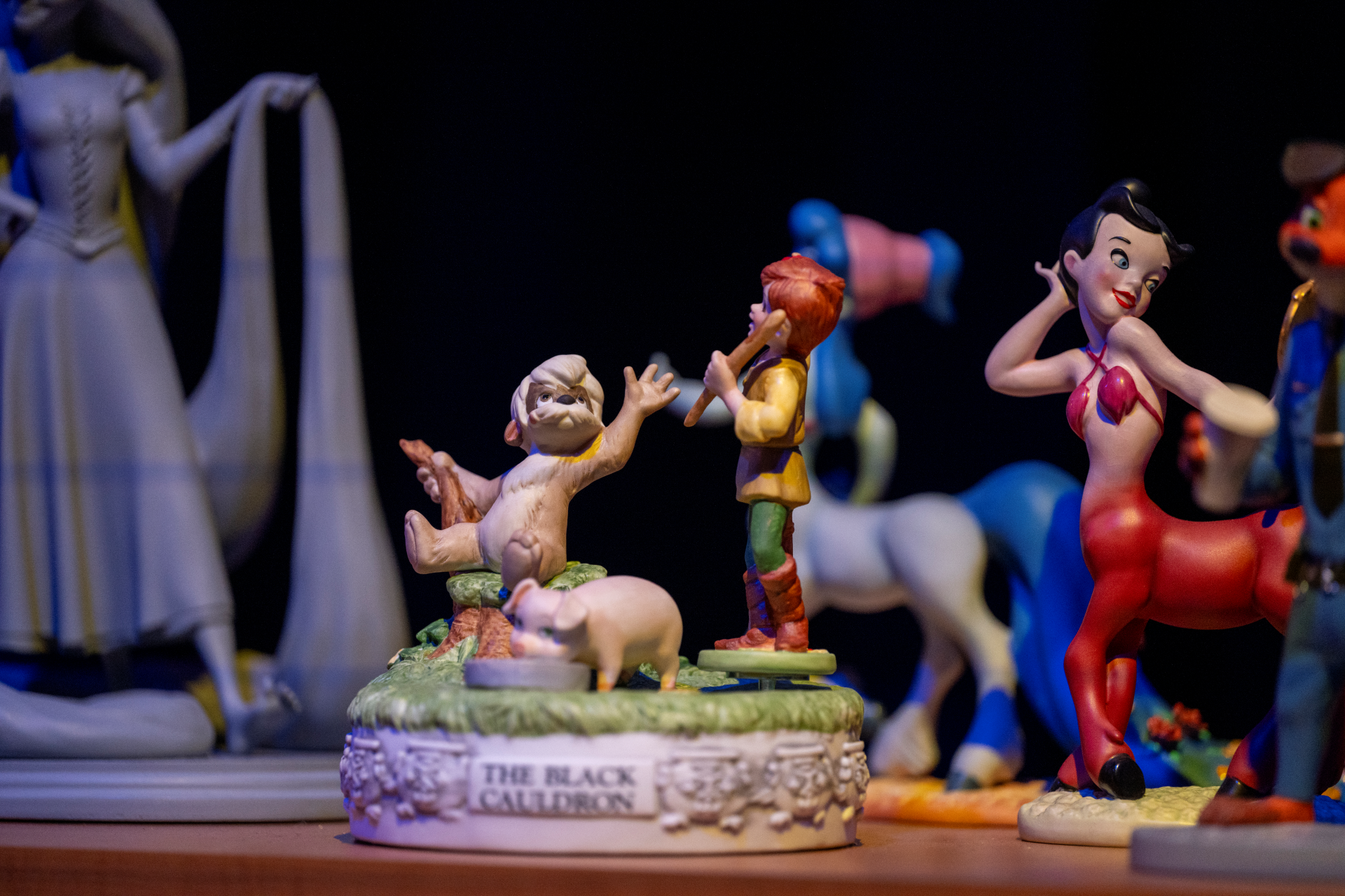 Figures from 'The Black Cauldron' displayed on a decorative base.