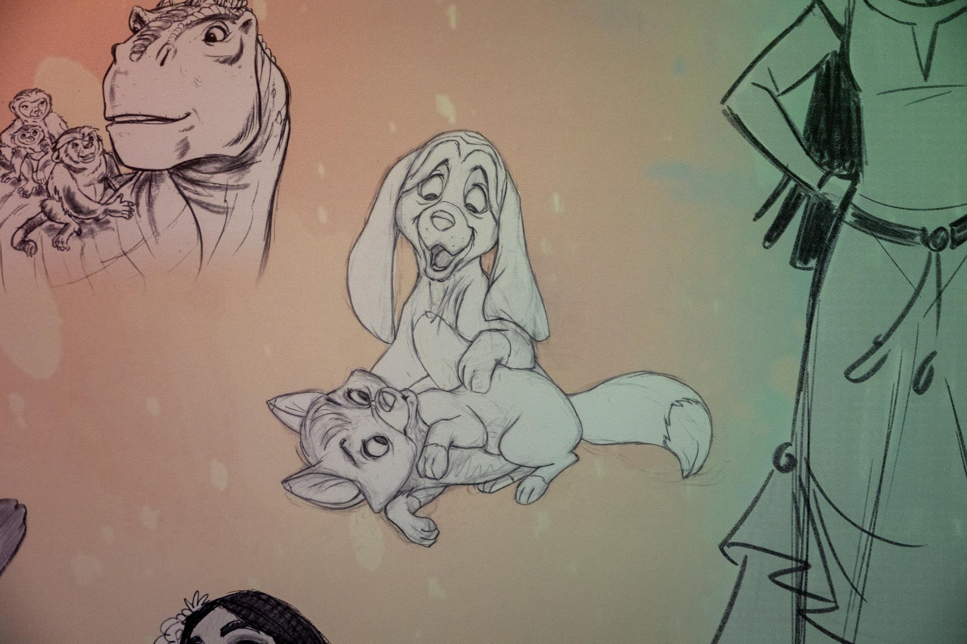 Sketches of animated characters, including dogs and a dinosaur.