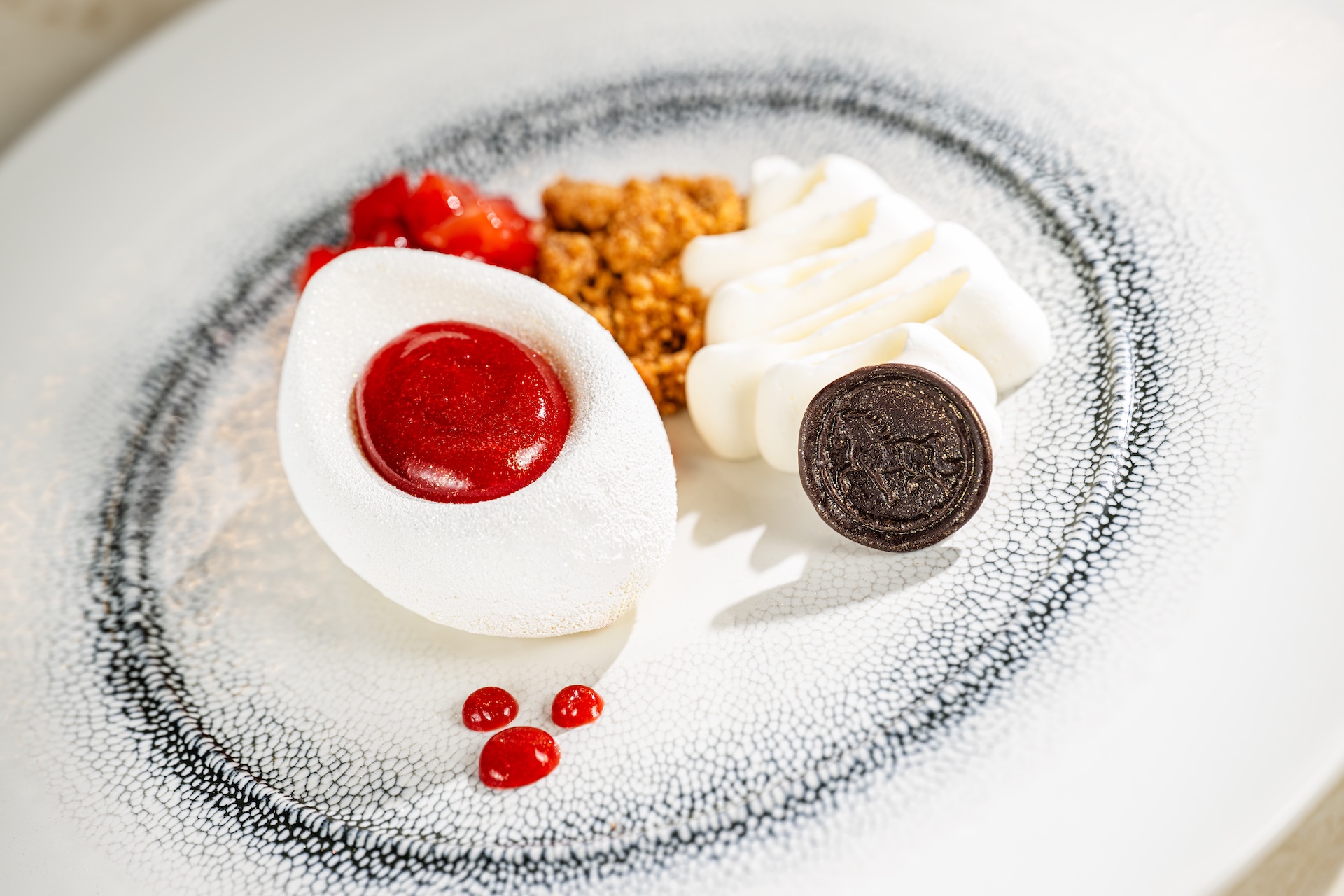 New York-style cheesecake with strawberry, cookie crumbles, and whipped cream.