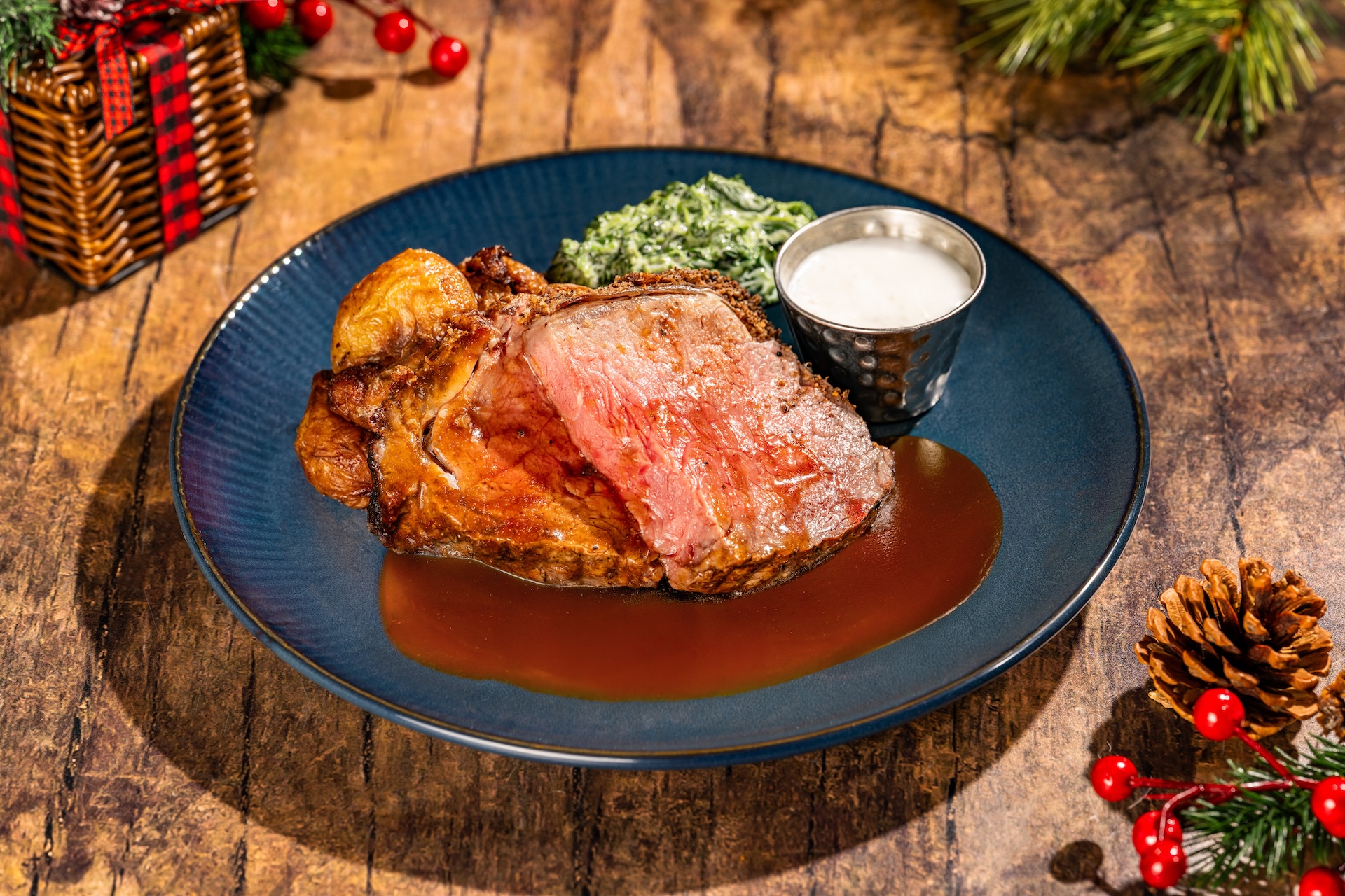 Slow-cooked Beef Strip Loin with herb crust, creamed spinach, roasted potatoes, creamy horseradish, and jus (Available during Mickey&rsquo;s Very Merry Christmas Party only) 