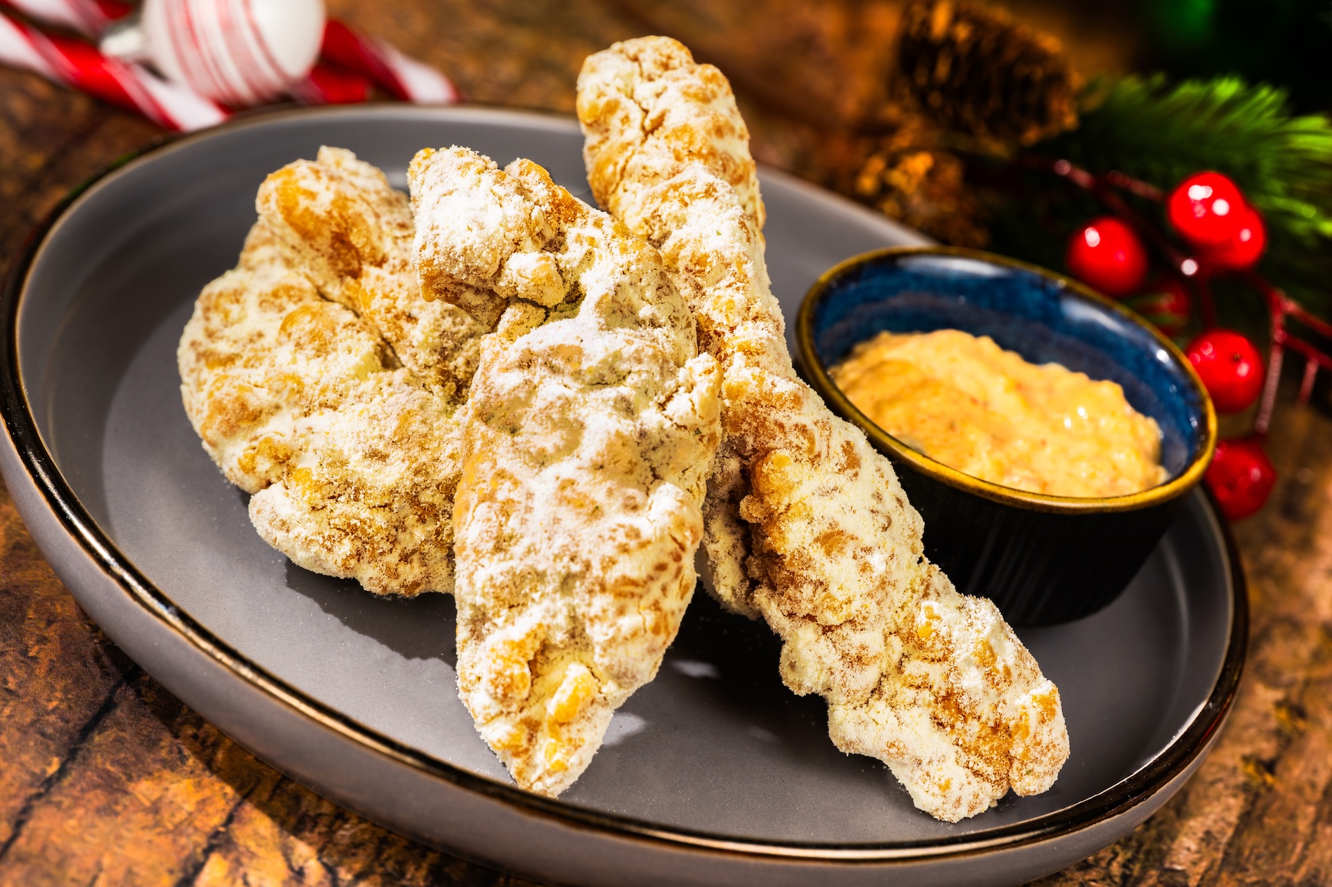 Snow Cheese Chicken Strips dusted with a sweet-and-savory white cheddar powder served with a side of kimchi a&iuml;oli and french fries (Available during Mickey&rsquo;s Very Merry Christmas Party only) 