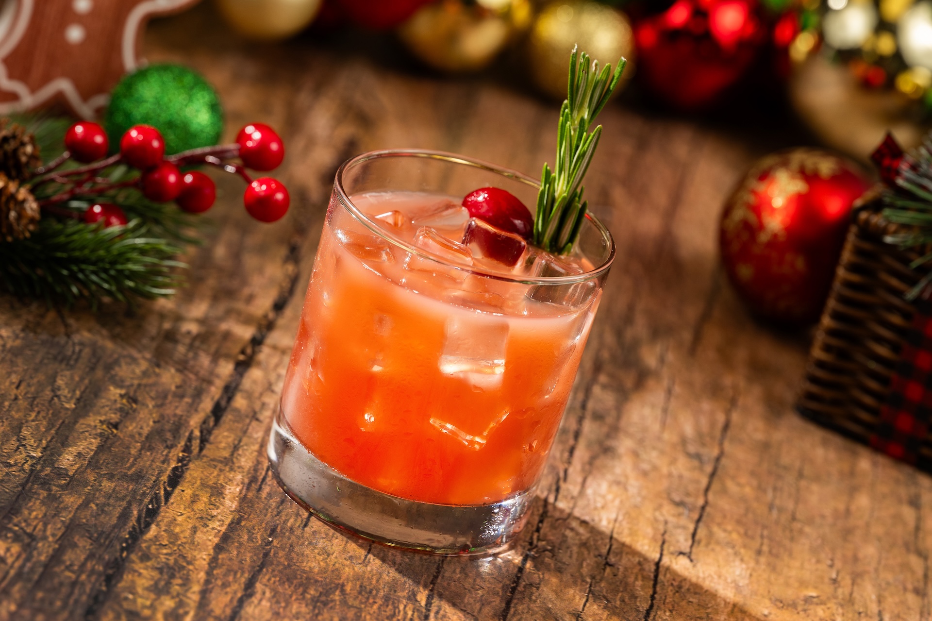Cranberry Christmas Cocktail: Fords Gin, cane syrup, cranberry juice, and Minute Maid Orange Juice garnished with cranberries and rosemary (Available during Mickey&rsquo;s Very Merry Christmas Party only) 