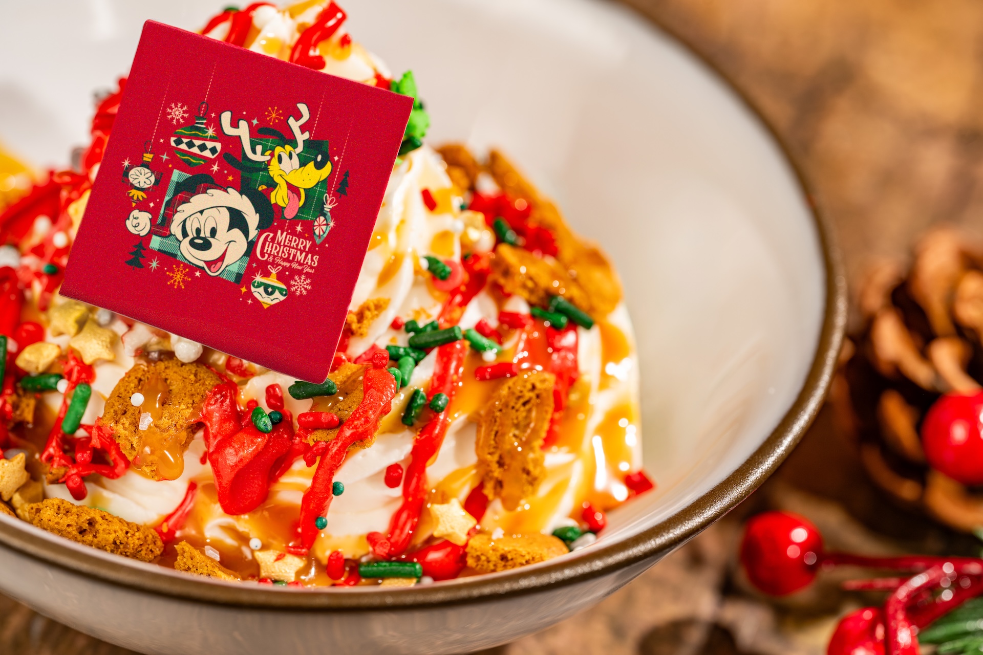 Very Merry Mickey Sundae: Vanilla soft-serve topped with whipped cream, gingersnap pieces, festive sprinkles, cherry coating, and chocolate d&eacute;cor (New) (Available during Mickey&rsquo;s Very Merry Christmas Party only) 